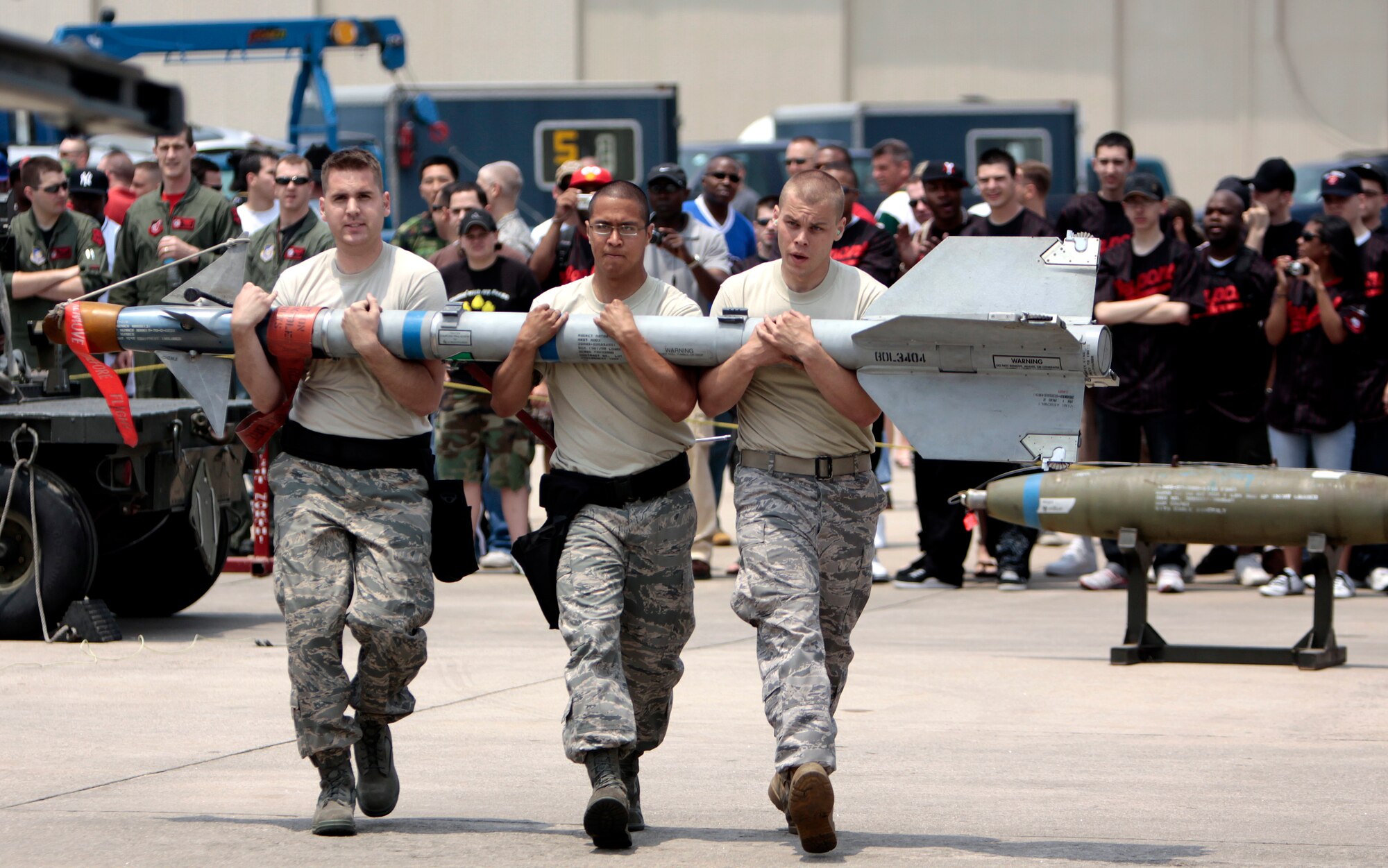 Airman 1st Class Adam Schad, Staff Sgt. Steven Ayala and Airman 1st Class Steven Roberson, 13th Aircraft Maintenance Unit weapons load crew members, carry a Captive AIM-9 Sidewinder missile to an F-16 Fighting Falcon during Weapons Fest at Suwon Air Base, South Korea, May 30, 2009. The 13th AMU finished first place in the F-16 category and second overall. (U.S. Air Force photo by Senior Master Sgt. Wayne Cardwell)