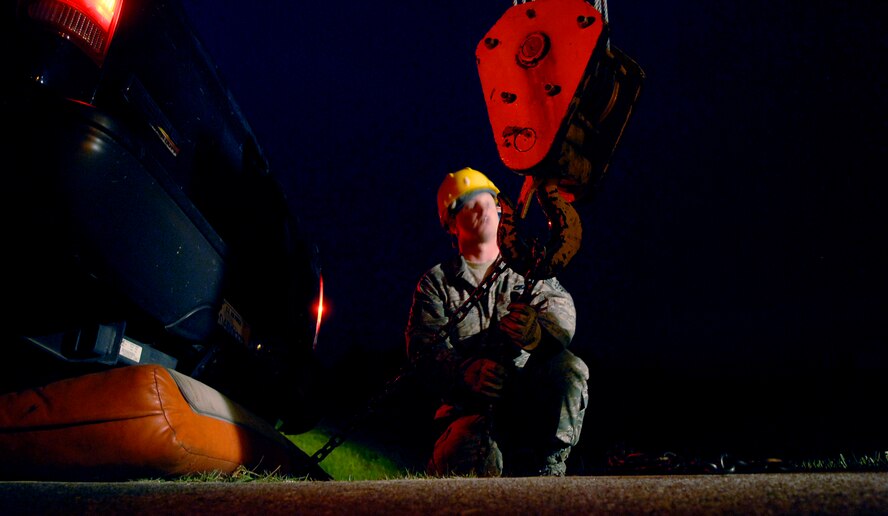 Staff Sgt. Kristopher Thornton guides the hoist of a 15-ton wrecker to the ground after a truck became stuck in a ditch on Osan Air Base, Republic of Korea, June 20.  Sergeant Thornton is a vehicle operator with the 51st Logistics Readiness Squadron. (U.S. Air Force photo/Staff Sgt. Brian Ferguson)