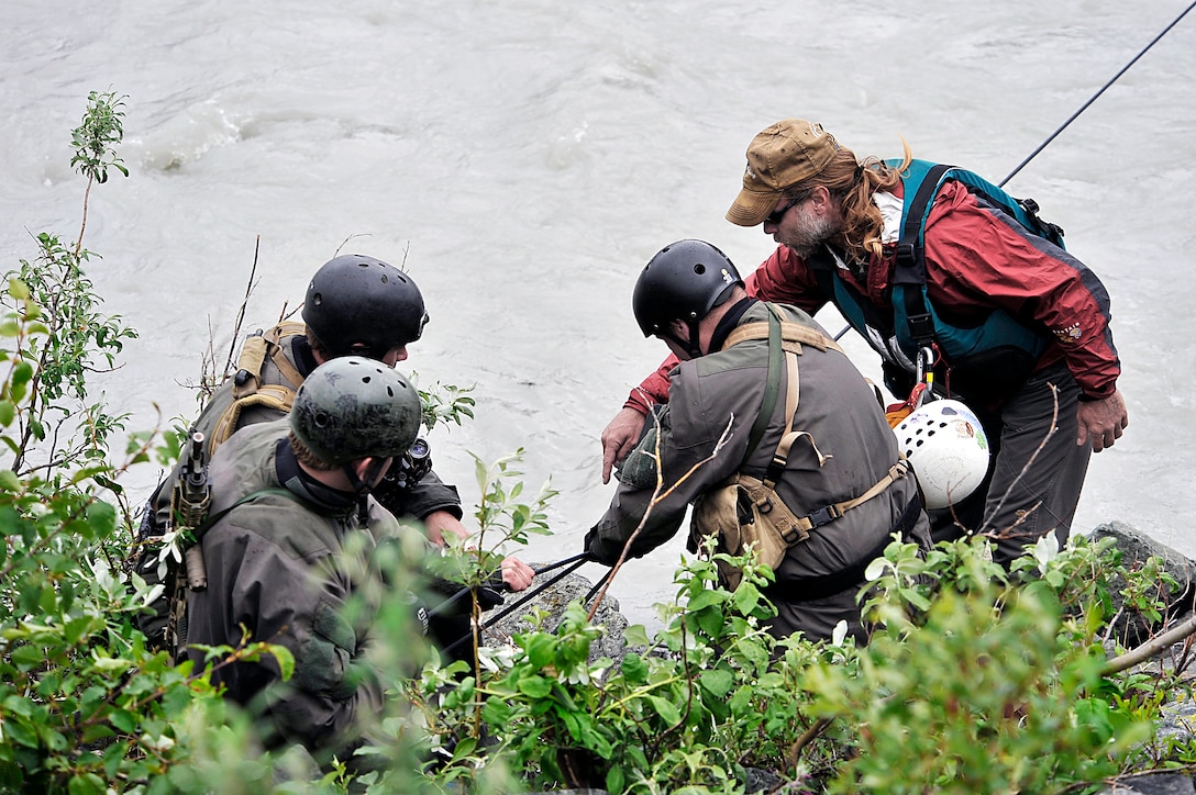 Steven Decker, right, teaches a group of U.S. Navy SEALs rope techniques during a river-crossing exercise during Northern Edge, a training exercise, on Fort Wainwright, Alaska, June 17, 2009. Decker is an instructor at the Northern Warfare Training Center. 