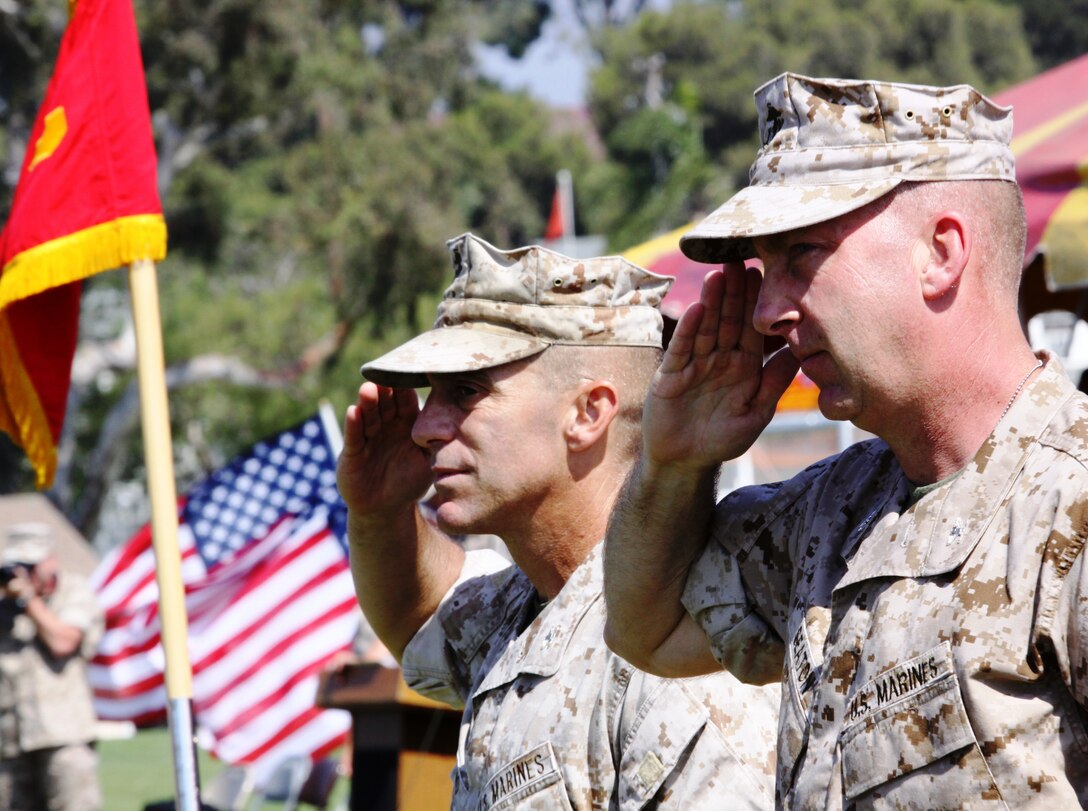 Col. Nicholas Marano (left) and Col. James B. Seaton III (right) salute during the pass and review portion of Camp Pendleton's change of command ceremony here, June 25. Marano assumed command of the Marine Corps' largest West Coast expeditionary training base from Seaton. ::r::::n::