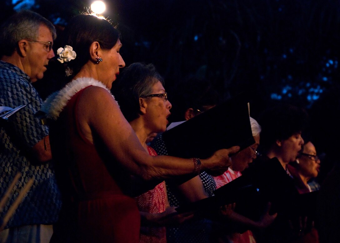 HONOLULU - A Kailua-based choir group sings with the Marine Corps Forces, Pacific Band June 26 at the Hale Koa Luau Gardens. The band usually performs in public, sometimes in unison with other groups, once a month to diversify their performances and foster community relations. (Official U.S. Marine Corps photo by Lance Cpl. Achilles Tsantarliotis)(Released)