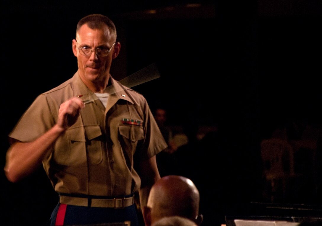 HONOLULU - Chief Warrant Officer 2 Bryan Sherlock, Marine Corps Forces, Pacific Band officer leads the Marines June 26 at the Hale Koa Luau Gardens. The MarForPac band took the night off from the usual ceremonial performance, opting instead for a more informal "jam" with a Kailua based choir group. (Official U.S. Marine Corps photo by Lance Cpl. Achilles Tsantarliotis)(Released)
