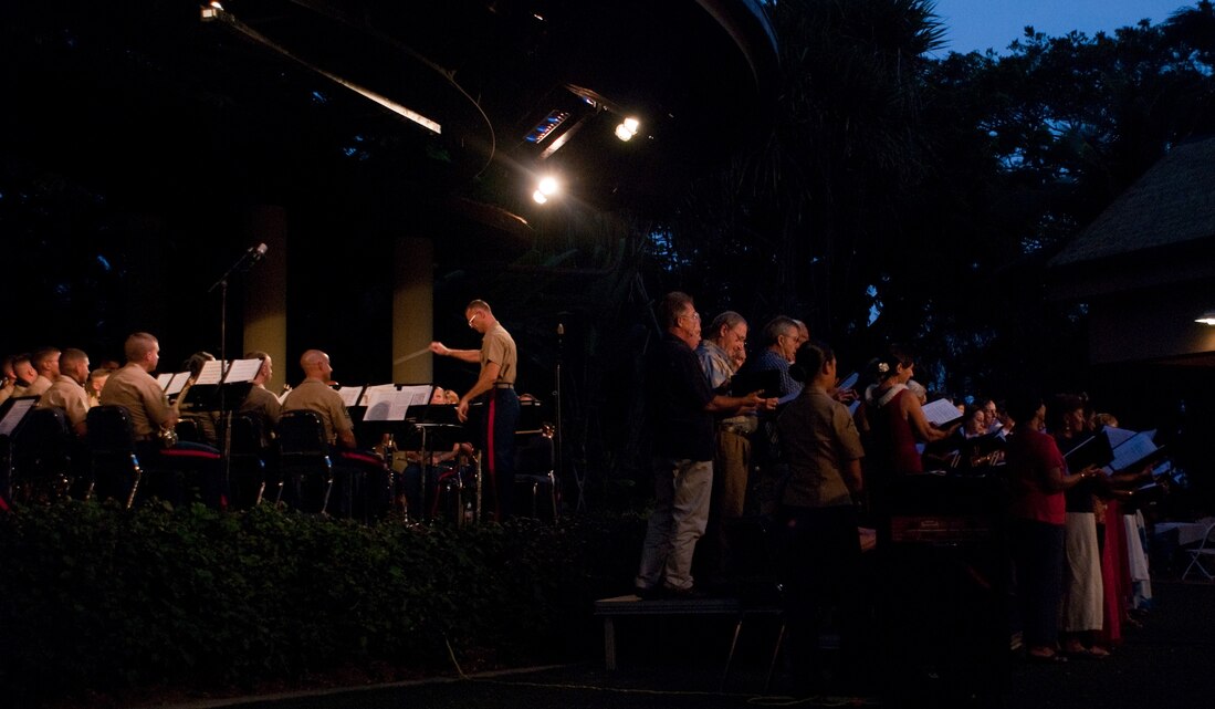 HONOLULU – Marines with Marine Corps Forces, Pacific Band perform with a Kailua-based choir group June 26 at the Hale Koa Luau Gardens. The performance substituted for their Fourth of July gig due to deploying in support of Operation Talisman Saber. (Official U.S. Marine Corps photo by Lance Cpl. Achilles Tsantarliotis)(Released)