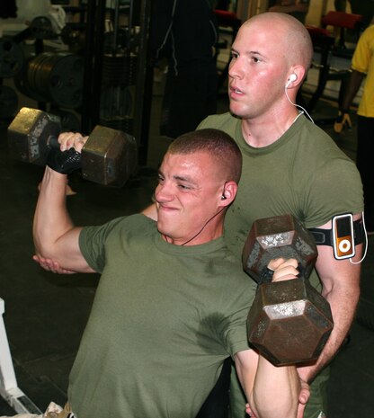 Sgt. Andrew L. Dekruiff, the security noncommissioned officer-in-charge at Al Taqaddum Surgical, 2nd Supply Battalion, 2nd Marine Logistics Group (Forward), spots his friend Petty Officer 3rd Class Korey M. Danico, a hospital corpsman with the emergency department of Al Taqaddum Surgical, during their strength workout at the gym aboard Camp Al Taqaddum, Iraq, June 26, 2009. The two service members have been working out together since April 2009. (U.S. Marine Corps photograph by Lance Cpl. Melissa A. Latty)