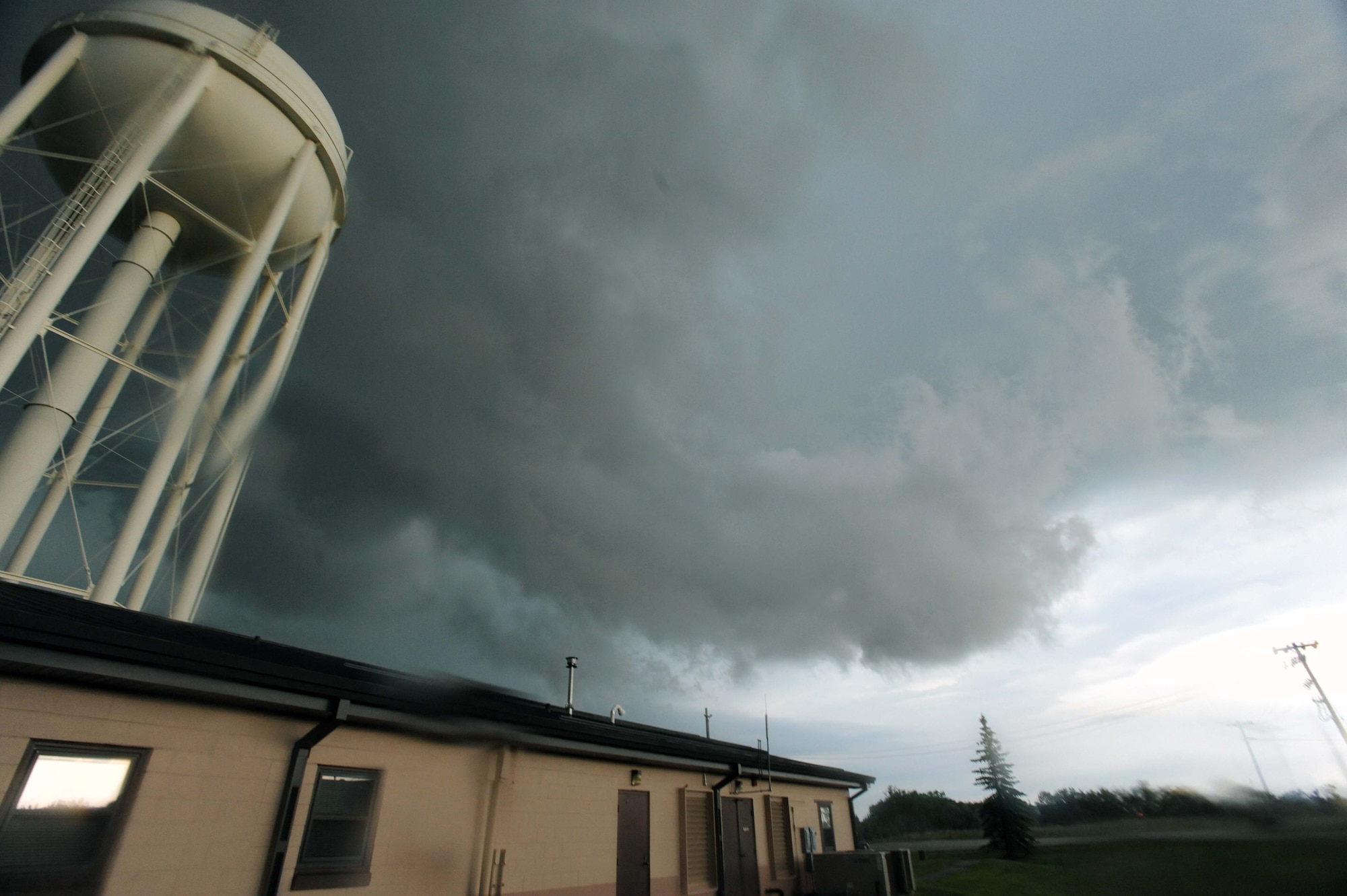 As the clouds swelled over Grand Forks Air Force Base and the Grand Forks region, members of the Incident Control Center leapt into action to protect Airmen and their families, as well as mitigate damage to property caused by tornadic activity and lightning strikes. Not long after sounding the tornado warning sirens and notifying the base community, a tornado was spotted less than 20 miles southeast of the base. (U.S. Air Force photo/Tech. Sgt. Johnny Saldivar)