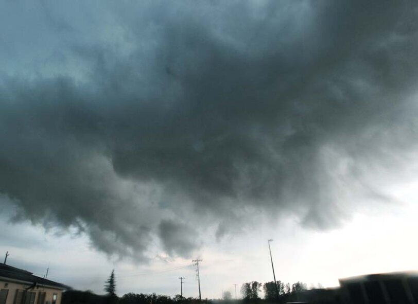 As the clouds swelled over Grand Forks Air Force Base and the Grand Forks region, members of the Incident Control Center leapt into action to protect Airmen and their families, as well as mitigate damage to property caused by tornadic activity and lightning strikes. Not long after sounding the tornado warning sirens and notifying the base community, a tornado was spotted less than 20 miles southeast of the base. (U.S. Air Force photo/Tech. Sgt. Johnny Saldivar)