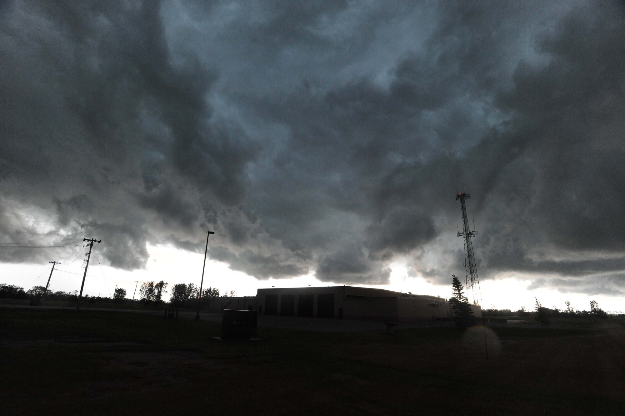 As the clouds swelled over Grand Forks Air Force Base and the Grand Forks region, members of the Incident Control Center leapt into action to protect Airmen and their families, as well as mitigate damage to property caused by tornadic activity and lightning strikes. Not long after sounding the tornado warning sirens and notifying the base community, a tornado was spotted less than 20 miles southeast of the base. (U.S. Air Force photo/Tech. Sgt. Johnny Saldivar)