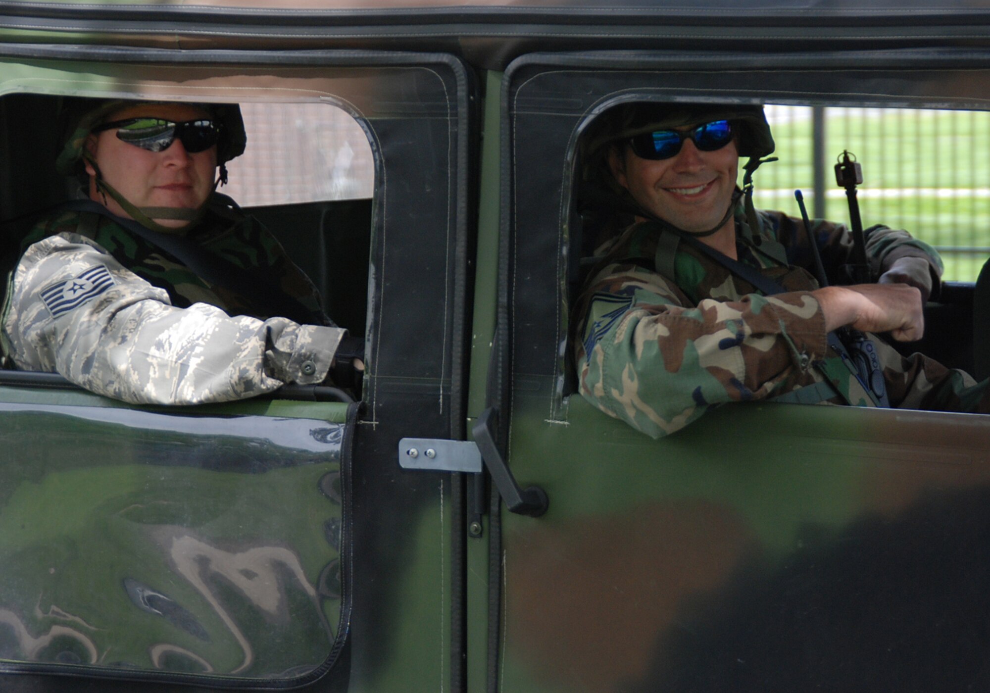 Two 932nd Airlift Wing civil engineers ride on truck patrol during the unit drill training at Scott Air Force Base near Belleville, Ill.  The wing has a variety of reserve jobs under the civil engineer's umbrella including structures, electricians, and heavy equipment operators.  (U.S. Air Force photo/Tech. Sgt. Danny Oliver)
