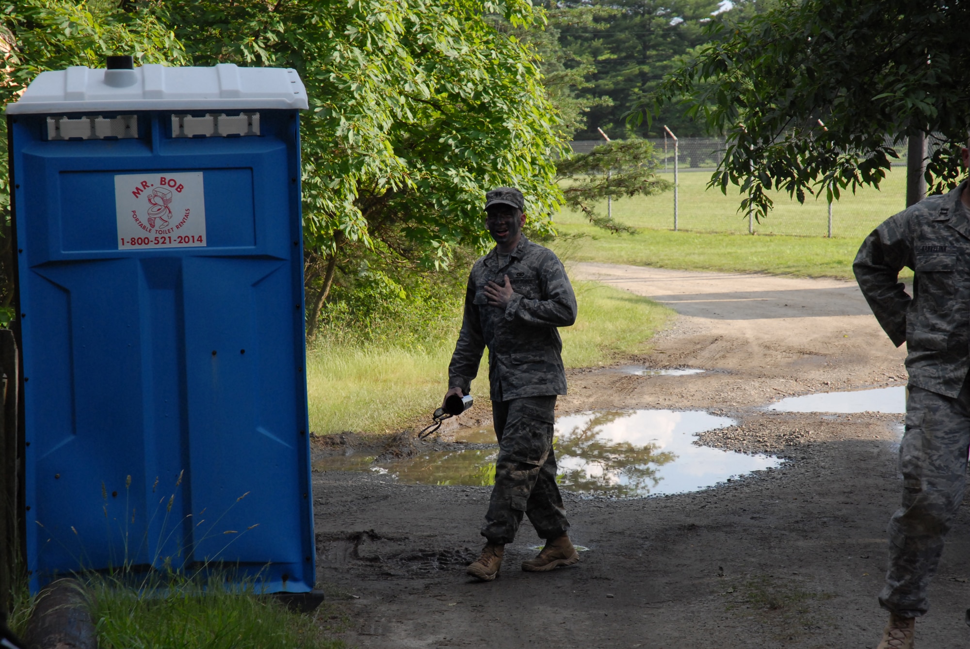 Captain Matthew Eckstein is taken by surprise when a booby-trap went off as he opened the door to the portable toilet during the 421 Combat Training Squadron Dinning In at Joint Base McGuire-Dix-Lakehurst, N.J. June 12, 2009. The 421 CTS conducts multiple pre-deployment training courses to include AMC?s Phoenix Raven, Fly-Away Security Team training, and the Chief of Staff of the Air Force?s EAGLE FLAG exercise.  (U.S. Air Force Photo/Tech. Sgt. Paul R. Evans)