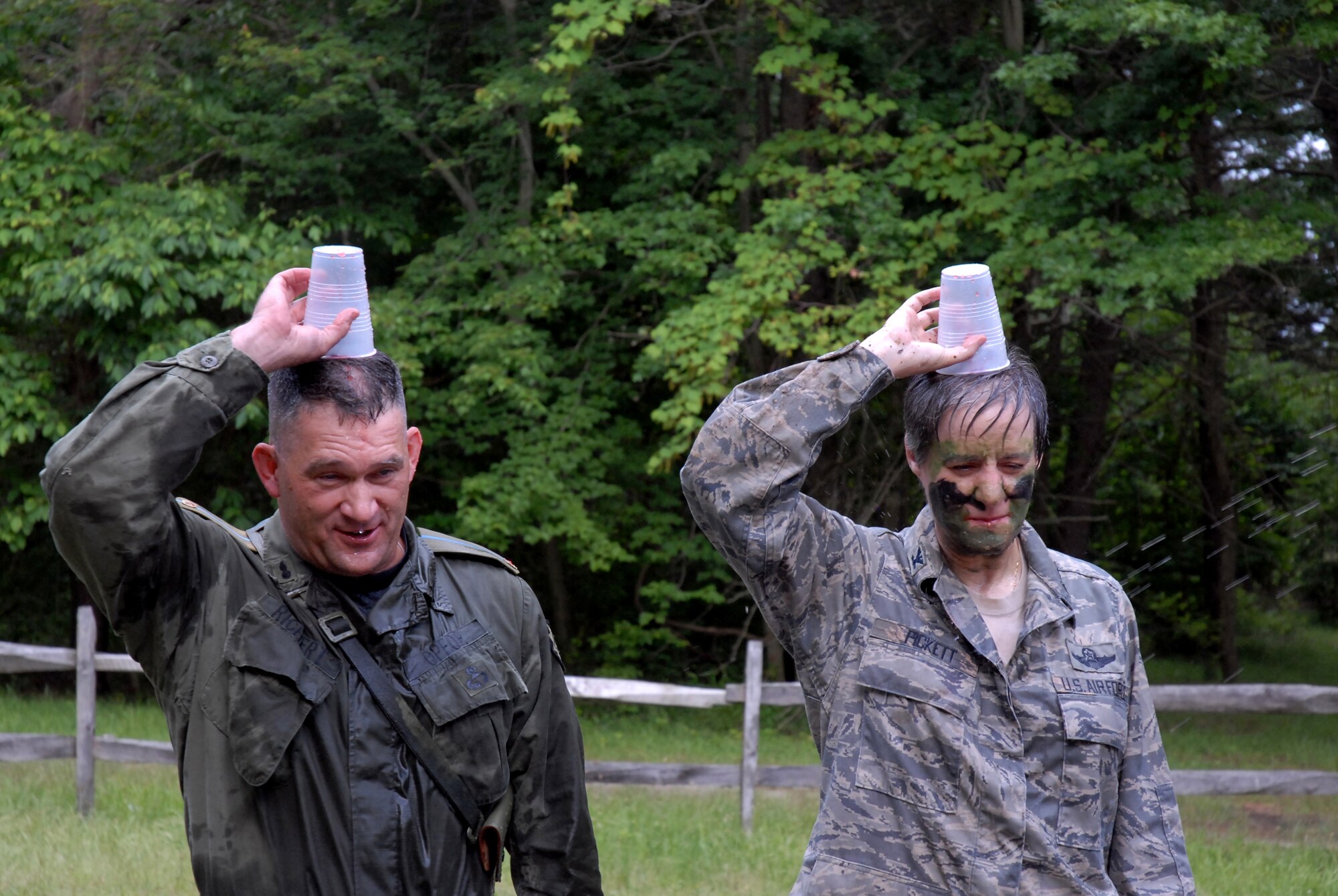 421st Combat Training Squadron Dining In guests, Colonels Randy Richert  and Jenny Pickett demonstrate to the President of the Mess that their grog cups are empty at Joint Base McGuire-Dix-Lakehurst, N.J. June 12, 2009. The 421 CTS conducts multiple pre-deployment training courses to include AMC?s Phoenix Raven, Fly-Away Security Team training, and the Chief of Staff of the Air Force?s EAGLE FLAG exercise.  (U.S. Air Force Photo/Tech. Sgt. Paul R. Evans)