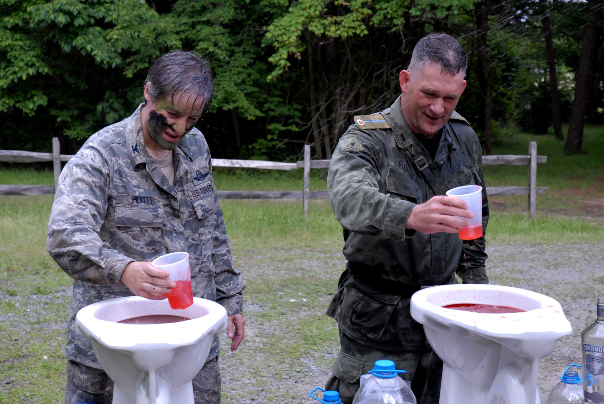 421st Combat Training Squadron Dining In guests, Colonels Randy Richert  and Jenny Pickett fill their grog cups before the President of the Mess at the grog bowel at Joint Base McGuire-Dix-Lakehurst, N.J. June 12, 2009. The 421 CTS conducts multiple pre-deployment training courses to include AMC?s Phoenix Raven, Fly-Away Security Team training, and the Chief of Staff of the Air Force?s EAGLE FLAG exercise.  (U.S. Air Force Photo/Tech. Sgt. Paul R. Evans)