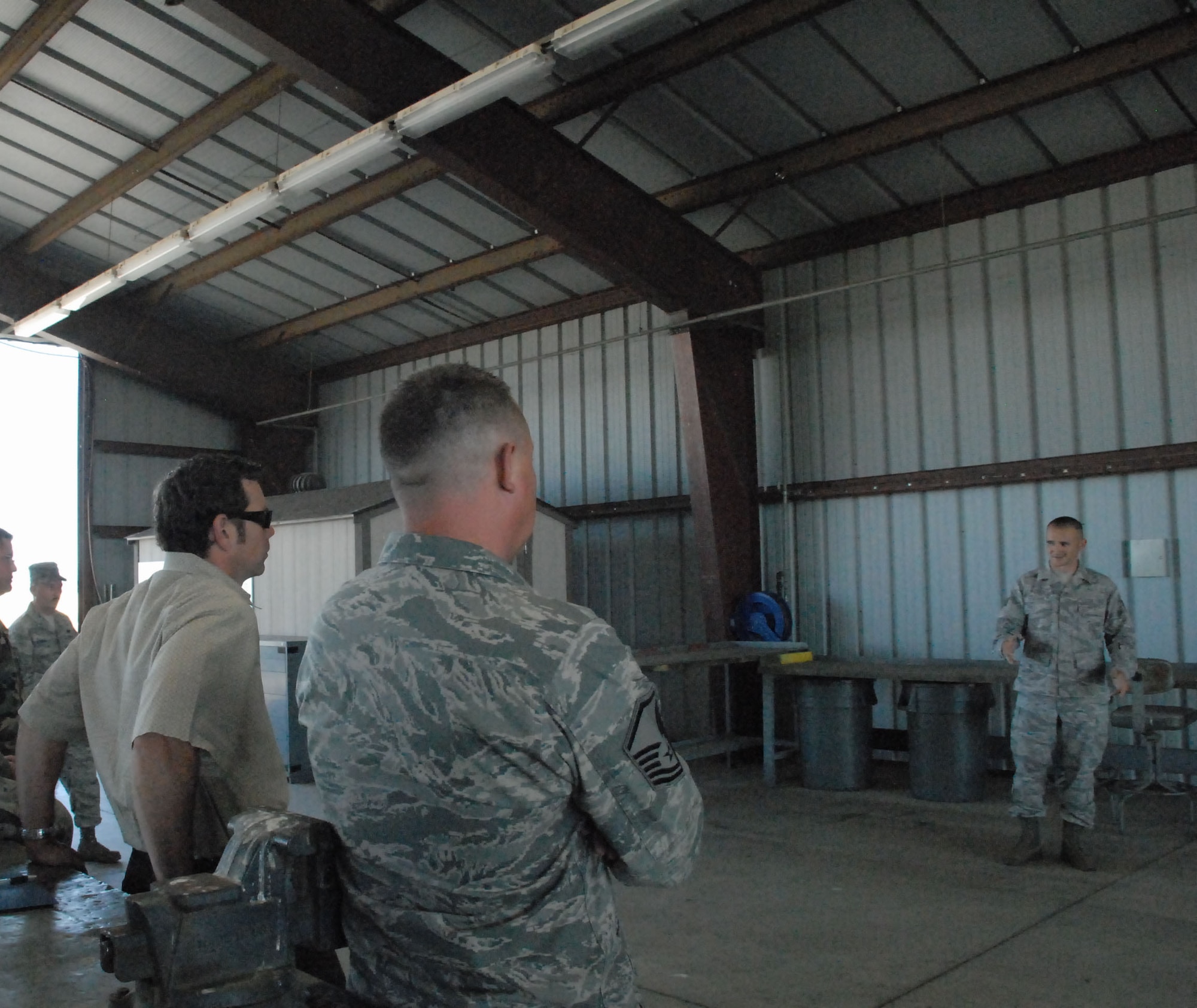 Staff Sgt. Nathan Scruggs explains how the the 9th MUNS handles munitons for training classes June 23 at the AFCOMAC training grounds. The squadron took part in a Value Stream Mapping event to improve the process they use for their Combat Ammuntion Planning and Production courses. (Tech Sgt. Luke Johnson)