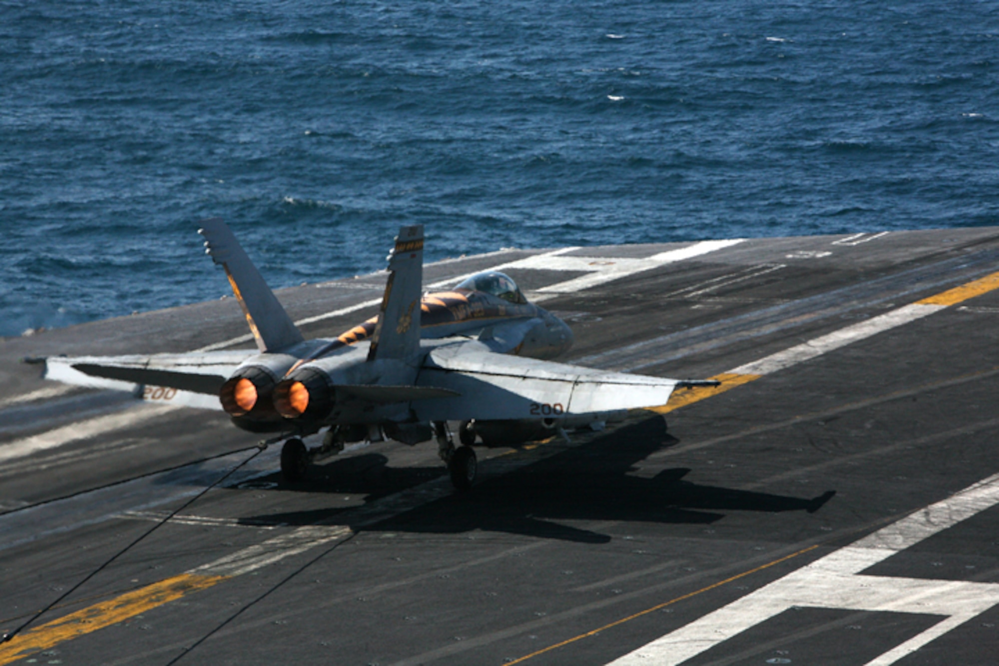 ELMENDORF AIR FORCE BASE, Alaska -- An arresting cable aboard the USS John C. Stennis (CVN-74) reins in the power of an F/A-18C Hornet flown by Marine Fighter Attack Squadron 323 after it lands on the flight deck June 23. The Stennis and the  5,000 servicemembers on board participated in one of the Department of Defense's premier joint training exercises, Northern Edge 2009. (U.S. Air Force photo/Marine Corps Sgt. Zachary Dyer)