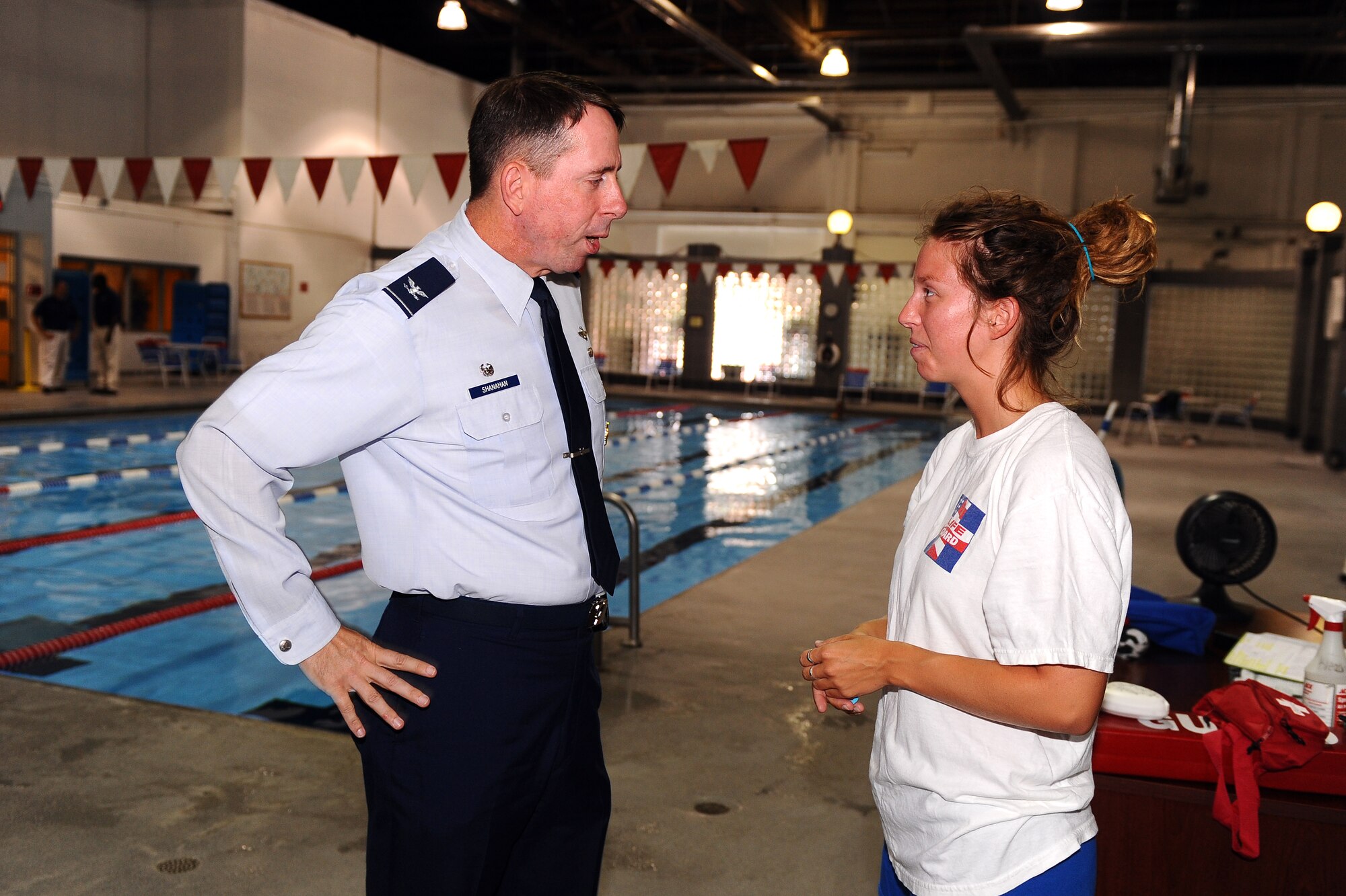 OFFUTT AIR FORCE BASE Neb. -- Col. John N.T. Shanahan, 55th Wing commander, thanks Rachel Buckner, a lifeguard with the 55th Force Support Squadron, at the Offutt Field House June 26, for her actions on June 23 that saved a six-year-old girl at the Caperhart Pool. Colonel Shanahan also presented Ms. Buckner with a commander's coin. U.S. Air Force Photo by Josh Plueger
