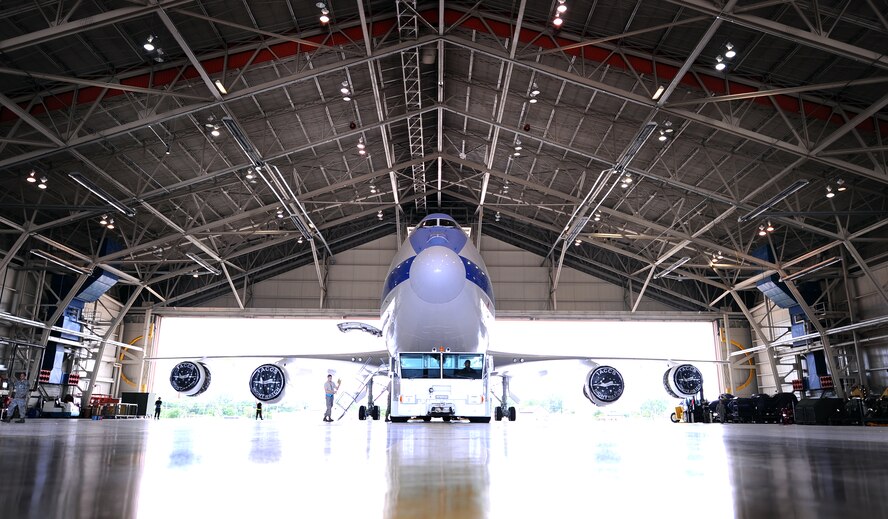 OFFUTT AIR FORCE BASE Neb.,-- An E-4B aircraft an emergency mobile command and control center, is towed out of its hangar at the east end of Offutt's runway June 17. The E-4B serves as the National Airborne Operations Center for the president, secretary of defense and the Joint Chiefs of Staff. If needed, the E-4B can provide a command, control and communications center to direct U.S. forces, execute emergency war orders and coordinate actions by civil authorities. U.S. Air Force Photo by Josh Plueger