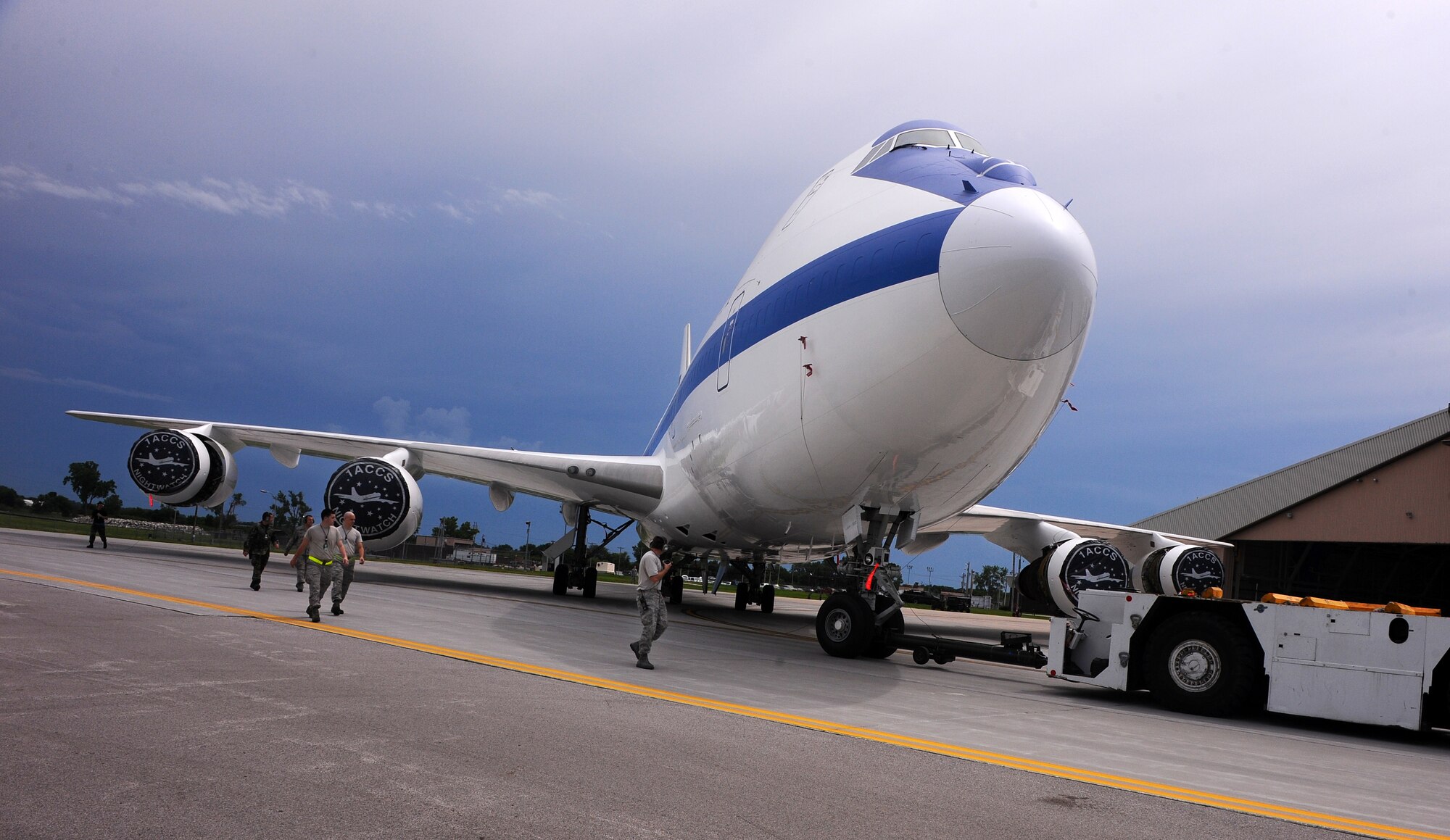 OFFUTT AIR FORCE BASE Neb.,--  An E-4B aircraft, an emergency mobile command and control center, is towed out of it's hangar at the east end of Offutt's runway June 17. The E-4B serves as the National Airborne Operations Center for the president, secretary of defense and the Joint Chiefs of Staff. If needed, the E-4B can provide a command, control and communications center to direct U.S. forces, execute emergency war orders and coordinate actions by civil authorities. U.S. Air Force Photo by Josh Plueger