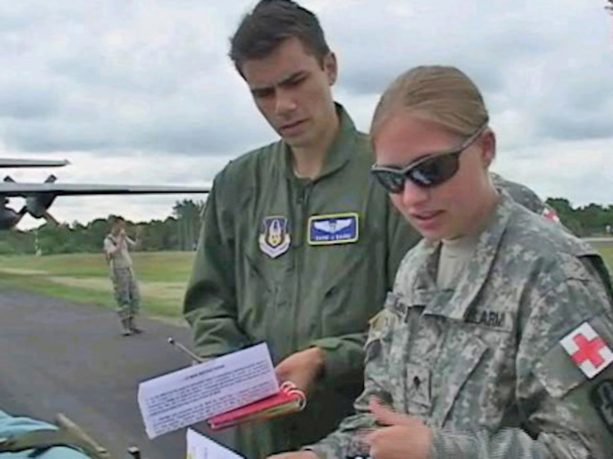 Second Lt. David Baure, a flight nurse with the 446th Aeromedical Evacuation Squadron, evaluates a patient with an Army Specialist during Global Medic, which took place June 6-18 at Fort McCoy, Wis. Global Medic is an annual exercise run by Army Reserve Command to apply the operational readiness of assigned medical units in a joint and coalition training environment. Incorporating both live and virtual simulation, this exercise provides realistic, battle-focused training scenarios.  