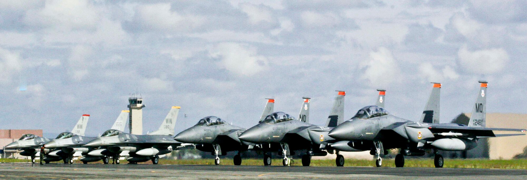 EIELSON AIR FORCE BASE, Alaska - Three F-15 fighter jets from Mountain Home Air Force Base, Idaho, and three F-16 fighter jets from Misawa Air Base, Japan, await their turn to launch at the end of Eielson's runway June 25, 2009. All six jets are preparing to participate in a joint training mission in the Gulf of Alaska as part of Exercise Northern Edge 2009. (U.S. Marine Corps photo by Lance Cpl. Ryan A. Rholes) (Released)