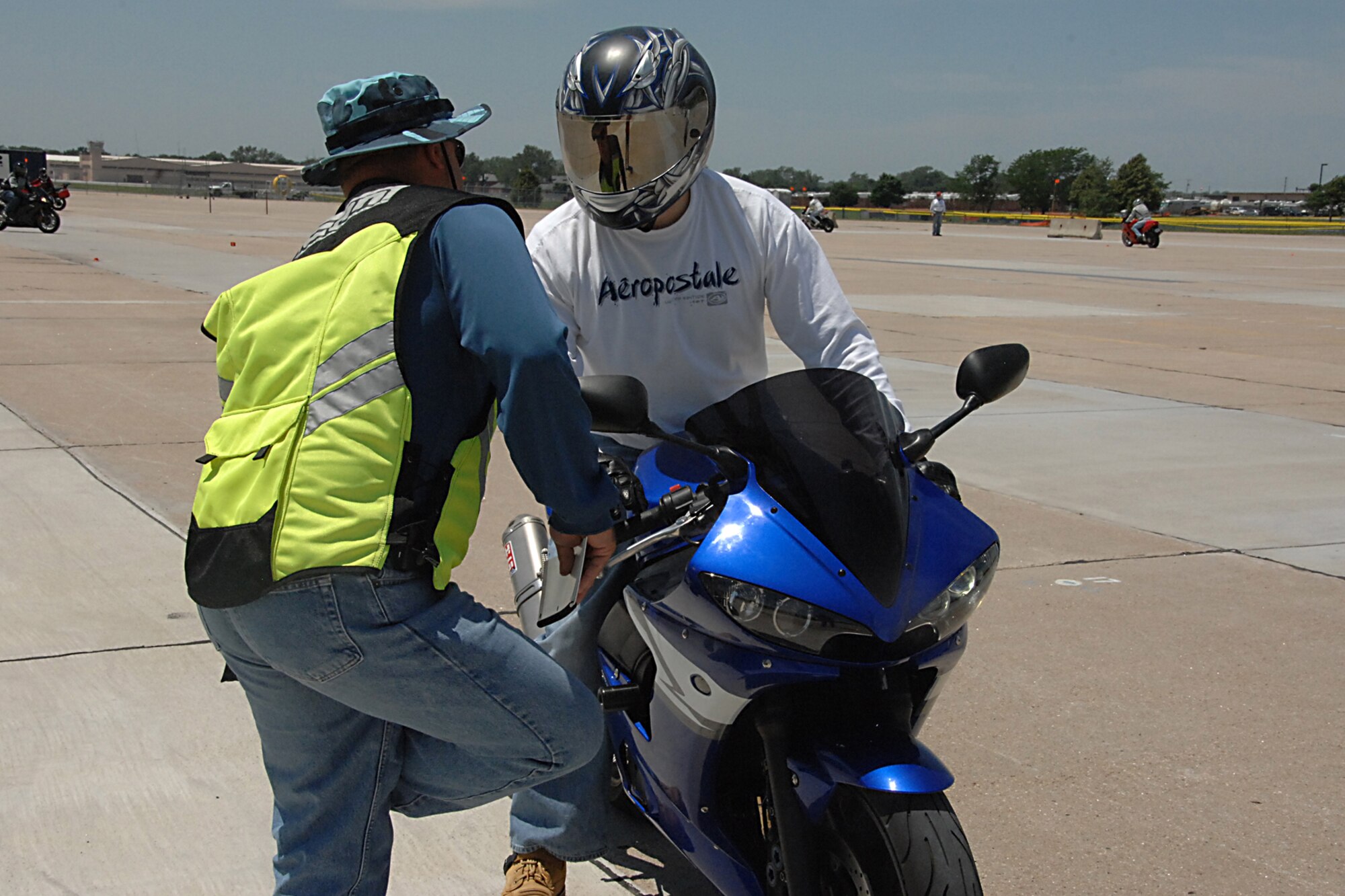 OFFUTT AIR FORCE BASE, Neb. -- Bobby Clark, a police officer with the Omaha Police Department and a Motorcycle Safety Foundation instructor, advises Staff Sgt. Justin Carpenter, 55th Maintenance Squadron, during the military sport bike safety course here June 18. The course was designed to give riders the necessary skills to prevent motorcycle mishaps. U.S. Air Force photo by Kendra Williams