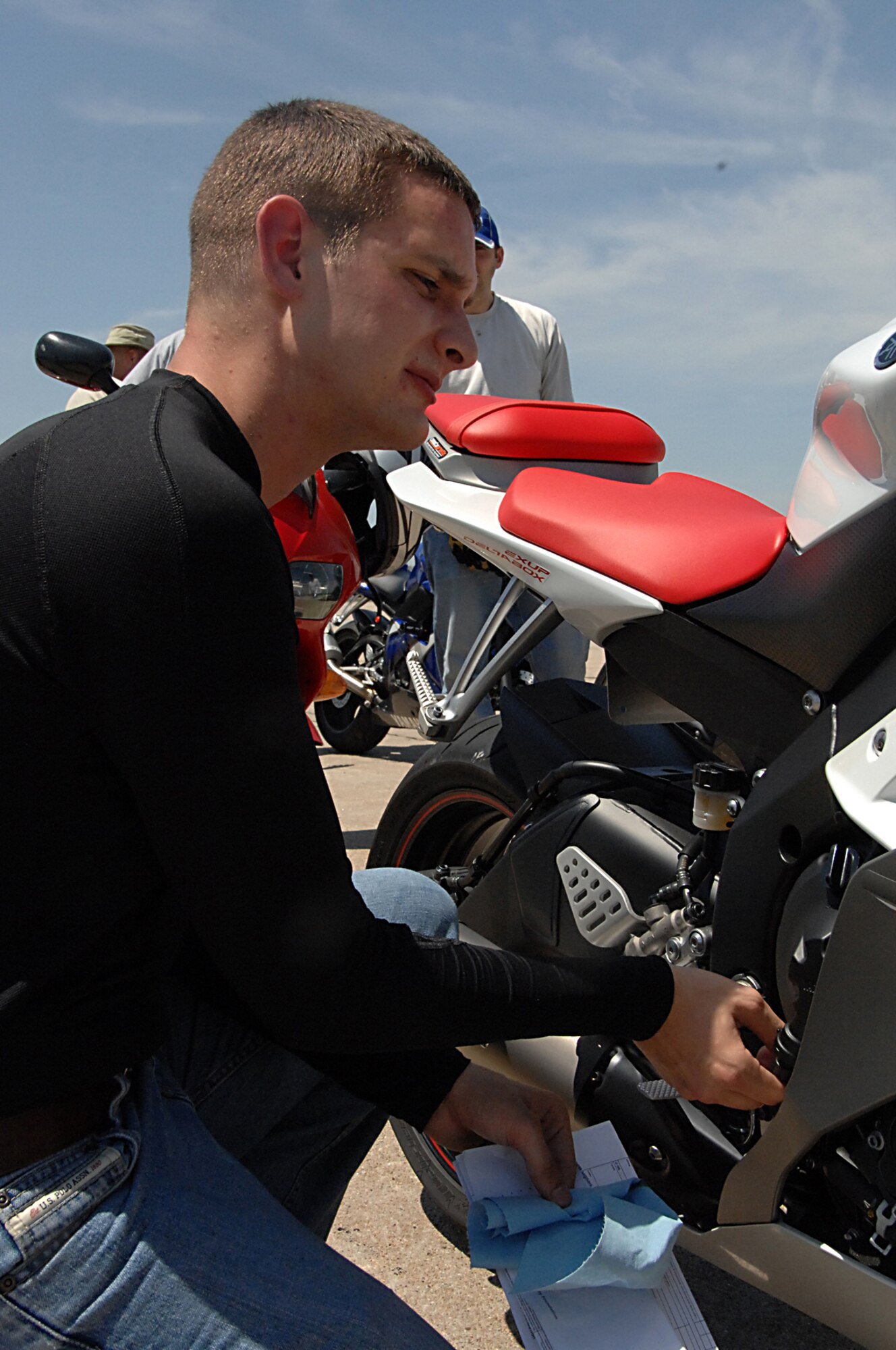 OFFUTT AIR FORCE BASE, Neb. -- Staff Sgt. Justin Martin, a hydro journeyman with the 55th Aircraft Maintenance Squadron, performs an oil check during the military sport bike rider course here June 18. The course was designed to give riders the necessary skills to prevent motorcycle mishaps. U.S. Air Force photo by Kendra Williams
