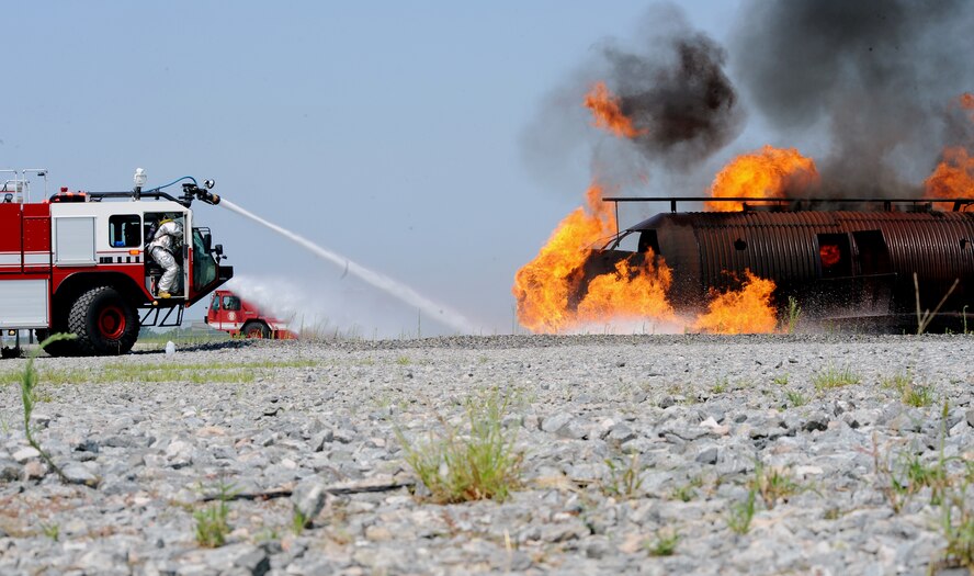 MOODY AIR FORCE BASE, Ga. -- Airmen from the 23rd Civil Engineer Squadron Fire Department extinguish a fire on a simulated HC-130P crash during a training exercise here June 25. The exercise is held quarterly to ensure 
Airmen can respond and control aircraft crash fires quickly. (U.S. Air Force
photo by Airman 1st Class Joshua Green)
