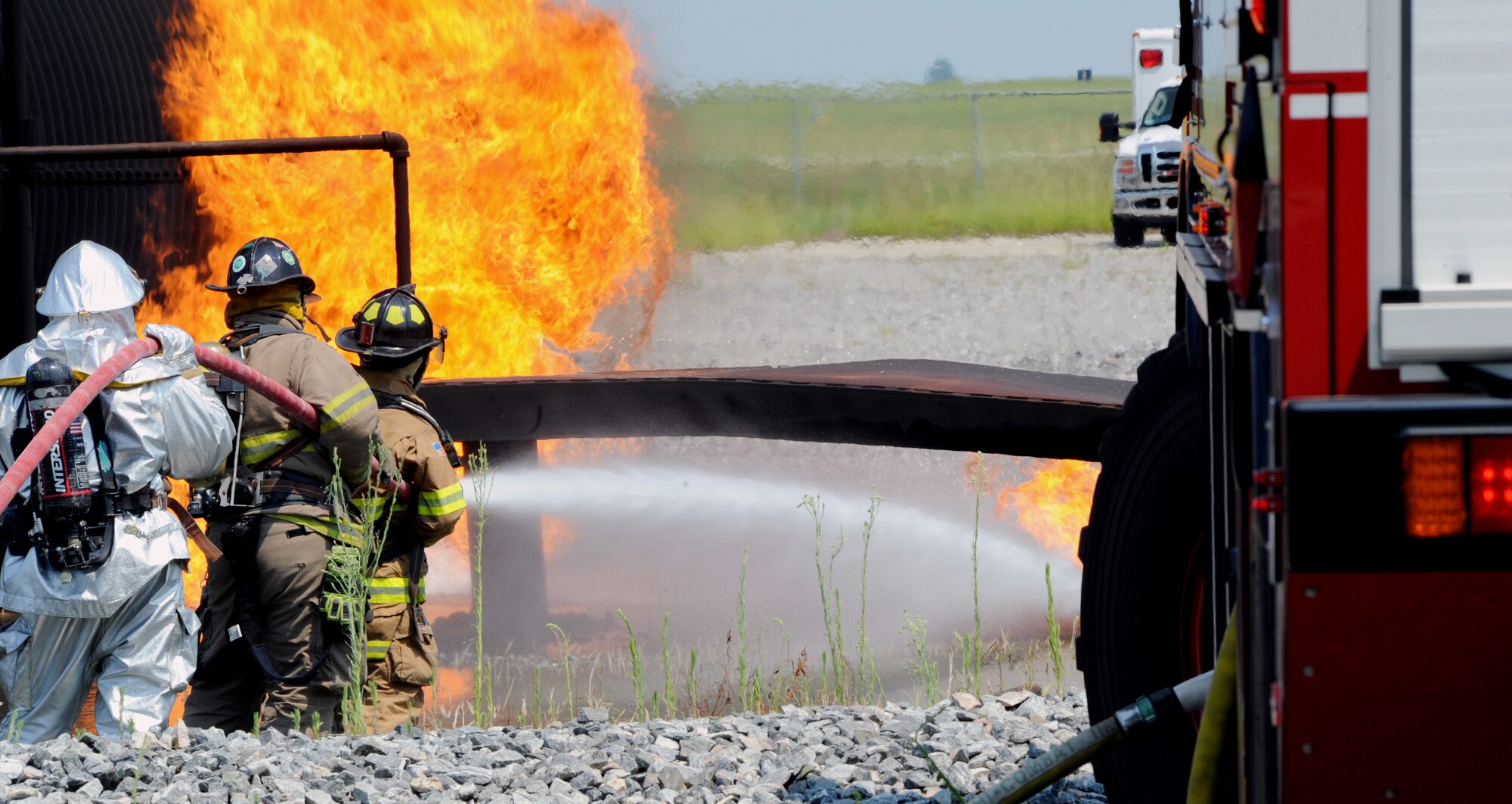 MOODY AIR FORCE BASE, Ga. -- Airmen from the 23rd Civil Engineer Squadron
and Valdosta Fire Department, spray water around a fire caused by a simulated HC-130P crash here June 25. The Valdosta Fire Department joined Moody in the training exercise. (U.S. Air Force photo by Airman 1st Class Joshua Green)
