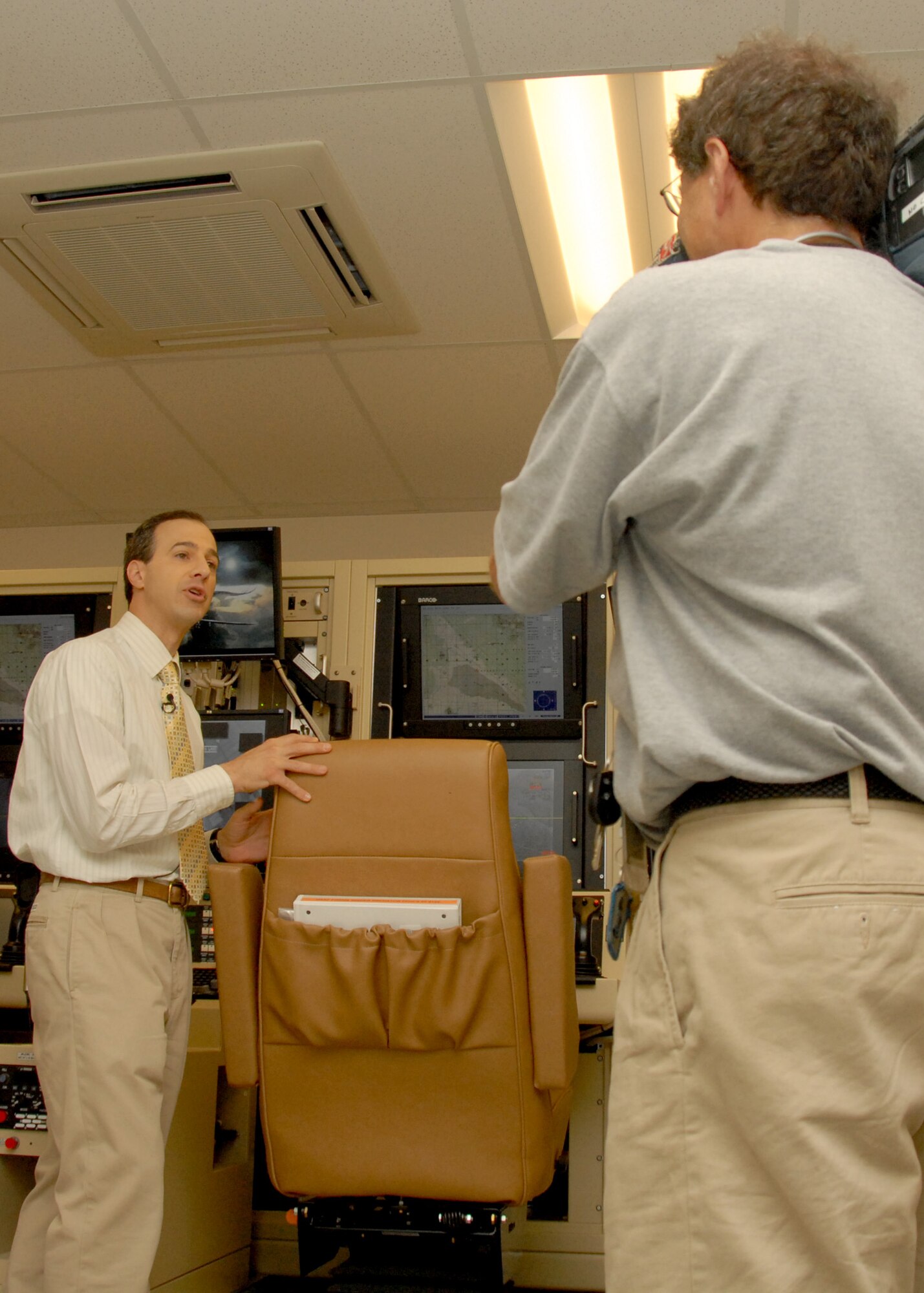 WSYR Syracuse News Channel 9 Reporter Jeff Kulikowsky leads into a news story in front of the Ground Control System that will support the new MQ-9 Reaper Unmanned Aerial Vehicle mission at Hancock Field in Syracuse, NY, on 26 June 2009. Kulikowsky was invited as part of the Media Day event introducing the new MQ-9 Reaper Unmanned Aerial Vehicle mission of the 174th Fighter Wing. (US Air Force photo by Tech. Sgt. Jeremy M. Call/Released)
