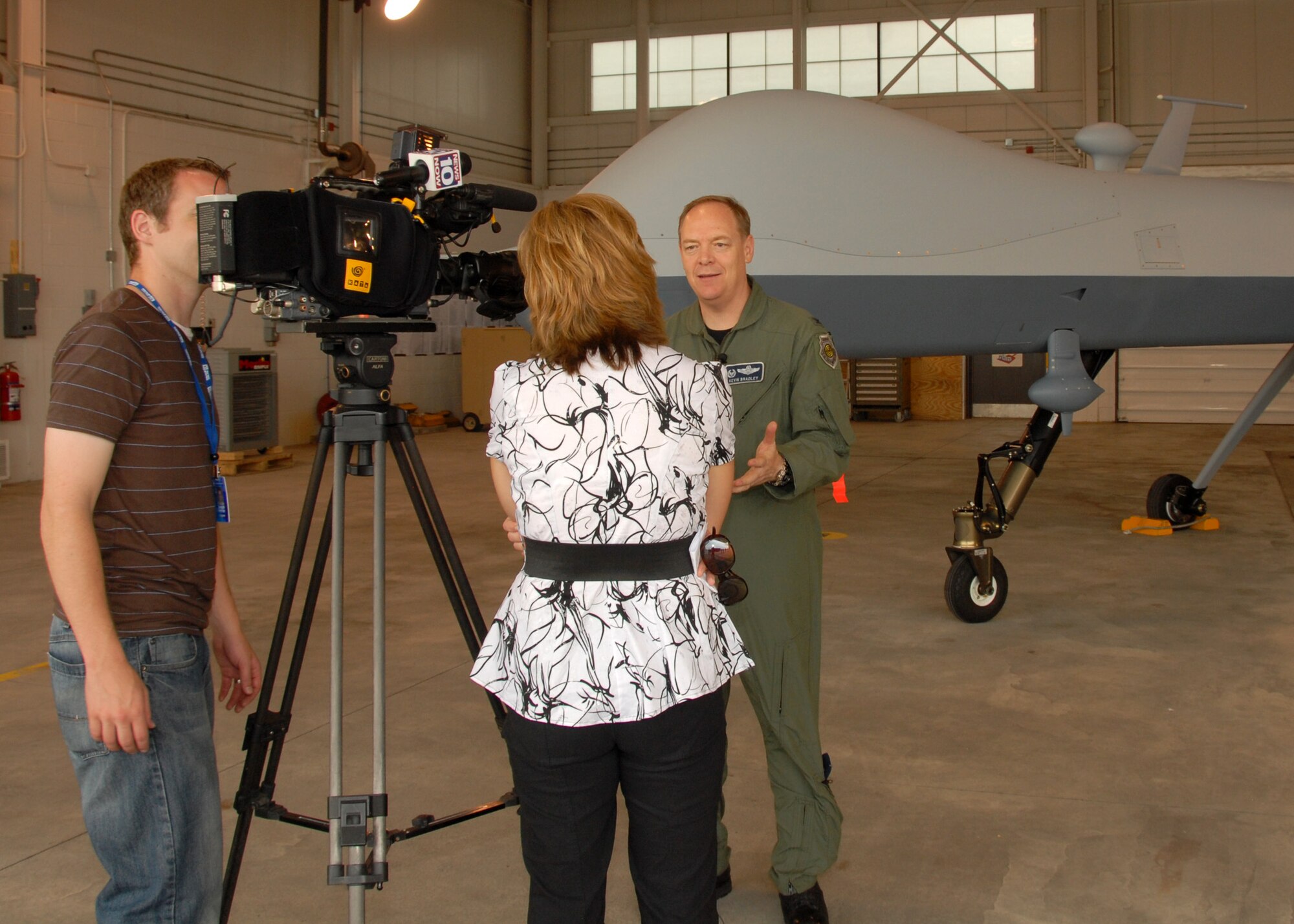 News 10 Now, Syracuse, Reporter Joleene Des Rosiers interviews New York Air National Guard, 174th Fighter Wing Commander, Col. Kevin W. Bradley in front of an MQ-9 Reaper Unmanned Aerial Vehicle at Hancock Field in Syracuse, NY, on 26 June 2009. Bradley was answering questions as part of the Media Day event introducing the new MQ-9 Reaper Unmanned Aerial Vehicle mission of the 174th Fighter Wing. (US Air Force photo by Tech. Sgt. Jeremy M. Call/Released)
