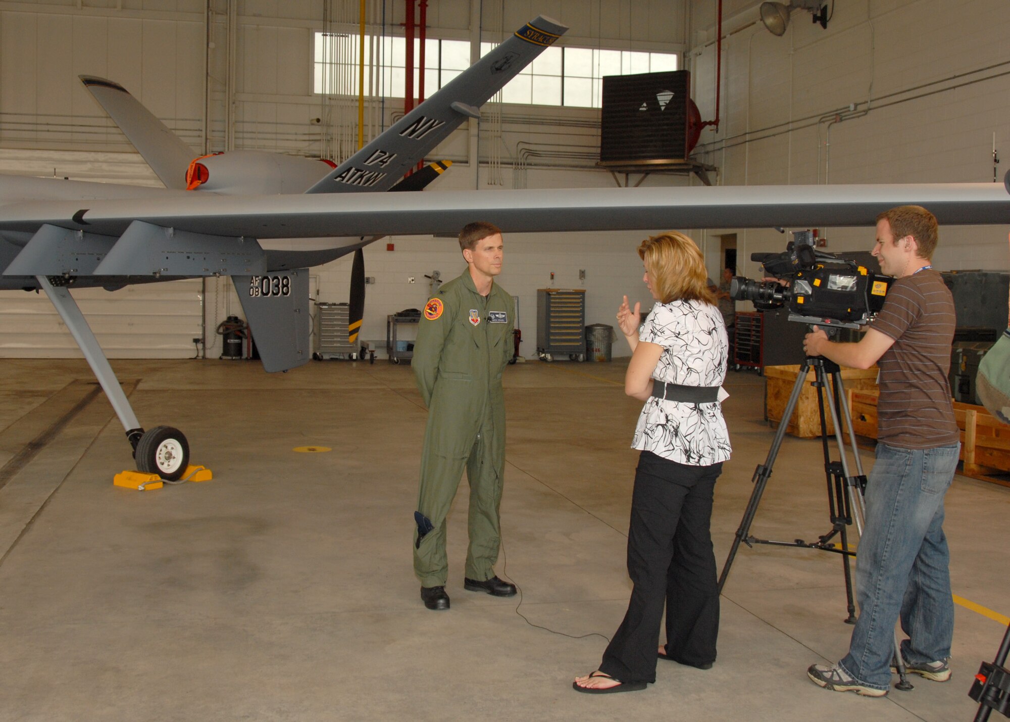 News 10 Now, Syracuse, Reporter Joleene Des Rosiers interviews New York Air National Guard, 174th Fighter Wing Operations Group Commander, Col. Greg Semmel in front of an MQ-9 Reaper Unmanned Aerial Vehicle at Hancock Field in Syracuse, NY, on 26 June 2009. Semmel was answering questions about the new 
MQ-9 Reaper UAV mission of the 174th Fighter Wing. (US Air Force photo by Tech. Sgt. Jeremy M. Call/Released)