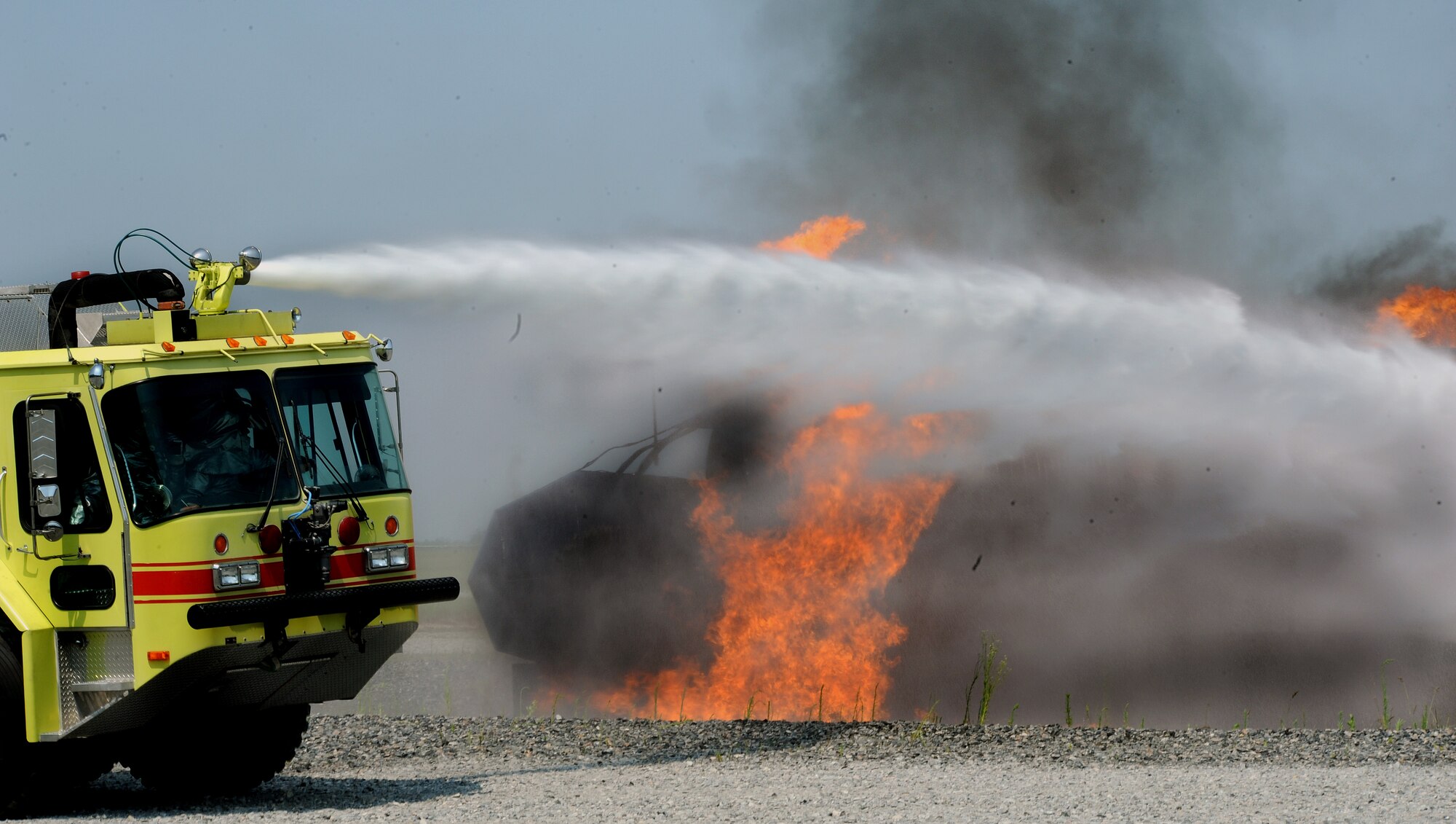 MOODY AIR FORCE BASE, Ga. -- A striker truck sprays water to extinguish a fire 
caused by a simulated HC-130P crash during a training exercise here June 25. The trucks are used until it is safe for Airmen to extinguish the fire on ground. (U.S. Air Force photo by Airman 1st Class Joshua Green)
