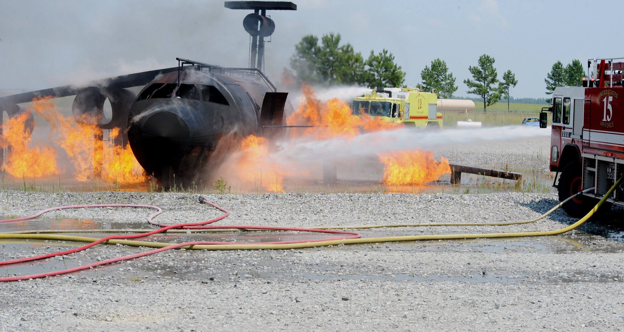 MOODY AIR FORCE BASE, Ga. -- Airmen from the 23rd Civil Engineer Squadron 
Fire Department utilize a striker truck to put out a fire caused by a simulated HC-130P crash here June 25. The 23rd CES was required to respond to the fire within a reasonable amount of time. (U.S. Air Force photo by Airman 1st Class Joshua Green)
