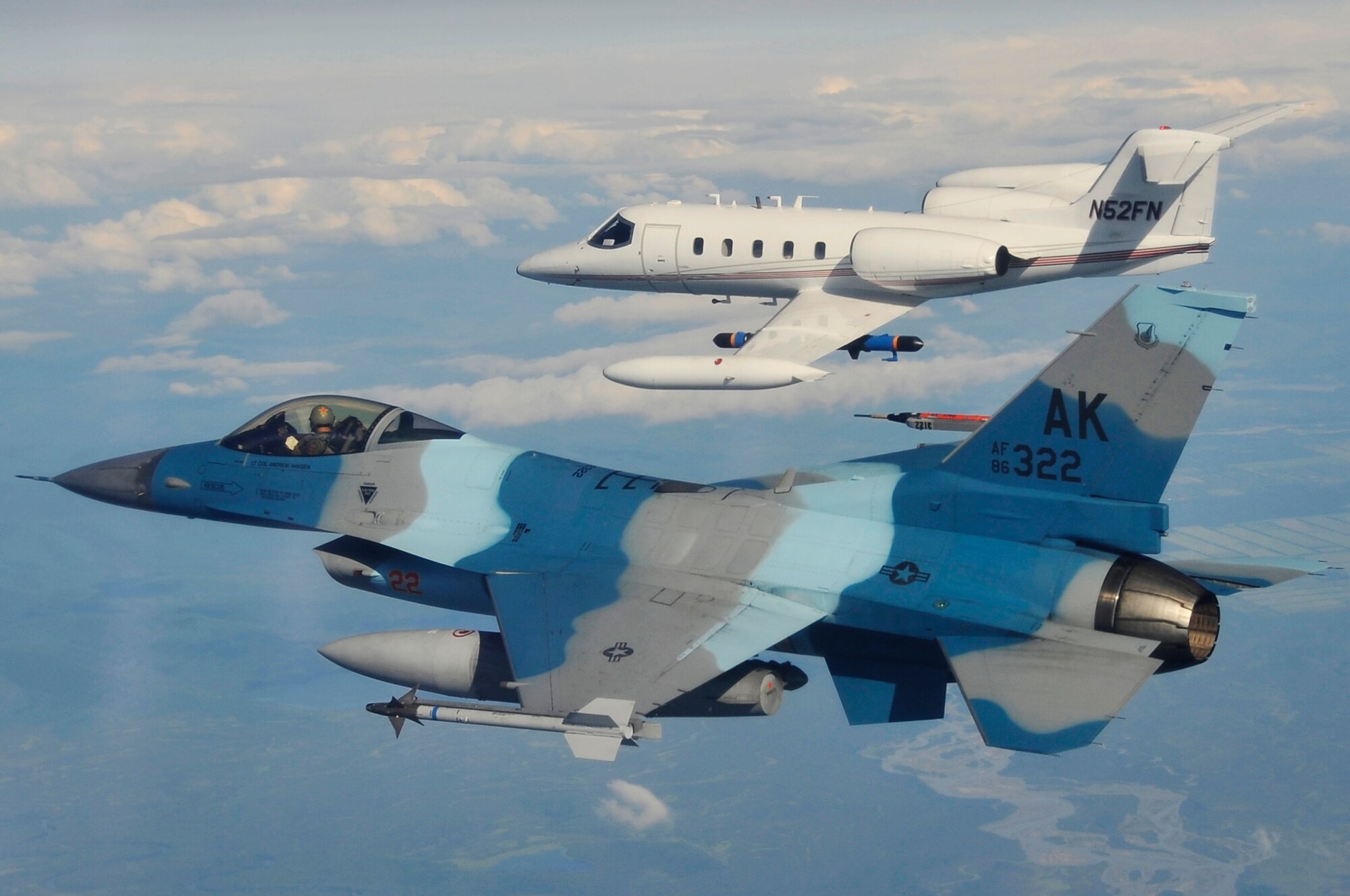 EIELSON AIR FORCE BASE, Alaska -- An F-16 Aggressor and a Learjet fly over the Joint Pacific Alaska Range Complex during NORTHERN EDGE 2009, June 25. NE09 participants practice tactics, techniques, and procedures associated with defensive counter-air, close air support, and personnel-recovery missions. The F-16 is assigned to the 18th Aggressor Squadron, Eielson AFB, Alaska. (U.S. Air Force photo/Staff Sgt. Christopher Boitz)
