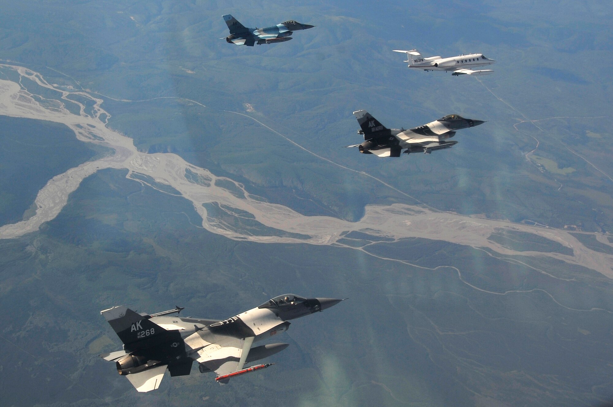 EIELSON AIR FORCE BASE, Alaska -- F-16 Aggressor's and a Learjet fly over the Joint Pacific Alaska Range Complex before attacking opposing forces during NORTHERN EDGE 2009, June 25. NE09 participants practice tactics, techniques, and procedures associated with defensive counter-air, close air support, and personnel-recovery missions. The F-16's are assigned to the 18th Aggressor Squadron, Eielson AFB, Alaska. (U.S. Air Force photo/Staff Sgt. Christopher Boitz)