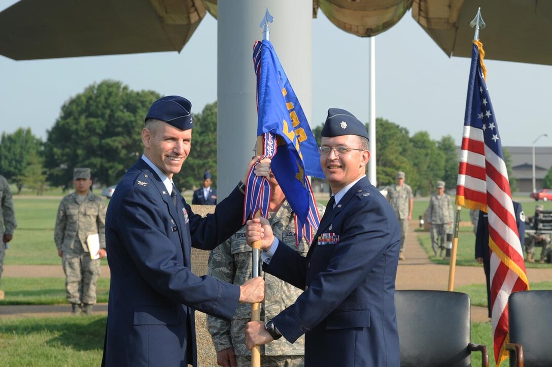 LANGLEY AIR FORCE BASE, Va. -- Col. Eric Ston, 1st Medical Group commander, passes the guideon to Lt. Col. Brent Erickson, 1st Medical Support Squadron commander, to show the new assumption of command. (U.S. Air Force photo/Senior Airman Scott Aldridge)