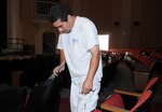 Arturo Nino, a contractor with Converse Painting, places a final coat on the theatre seats June 26. Officials expect renovations on the theatre to wrap up in mid-July. (U.S. Air Force photo by Don Lindsey)