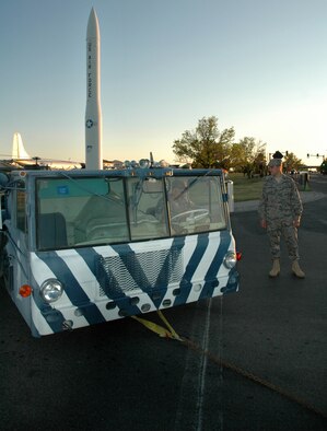 Capt. Allen Miller, 341st Logistics Readiness Squadron deployment and distribution flight chief watches Master Sgt. James Ferrenberg, 341st LRS vehicle operations superintendent, steer a 1962 transporter erector near the Malmstrom Museum June 3 as it is towed to the allied trades shop to be repainted. (U.S. Air Force photo/Senior Airman Dillon White)