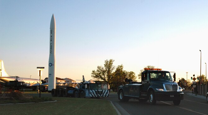 Tech. Sgt. Gary Hohnecker, 341st Logistics Readiness Squadron vehicle operator, tows Master Sgt. Ferrenberg, 341st LRS vehicle operations superintendent, who is behind the wheel of a 1962 transporter erector that has been on display at the Malmstrom Museum since 1991. The NCOs are towing the vehicle to allied trades, where it will be sanded and repainted. (U.S. Air Force photo/Senior Airman Dillon White)