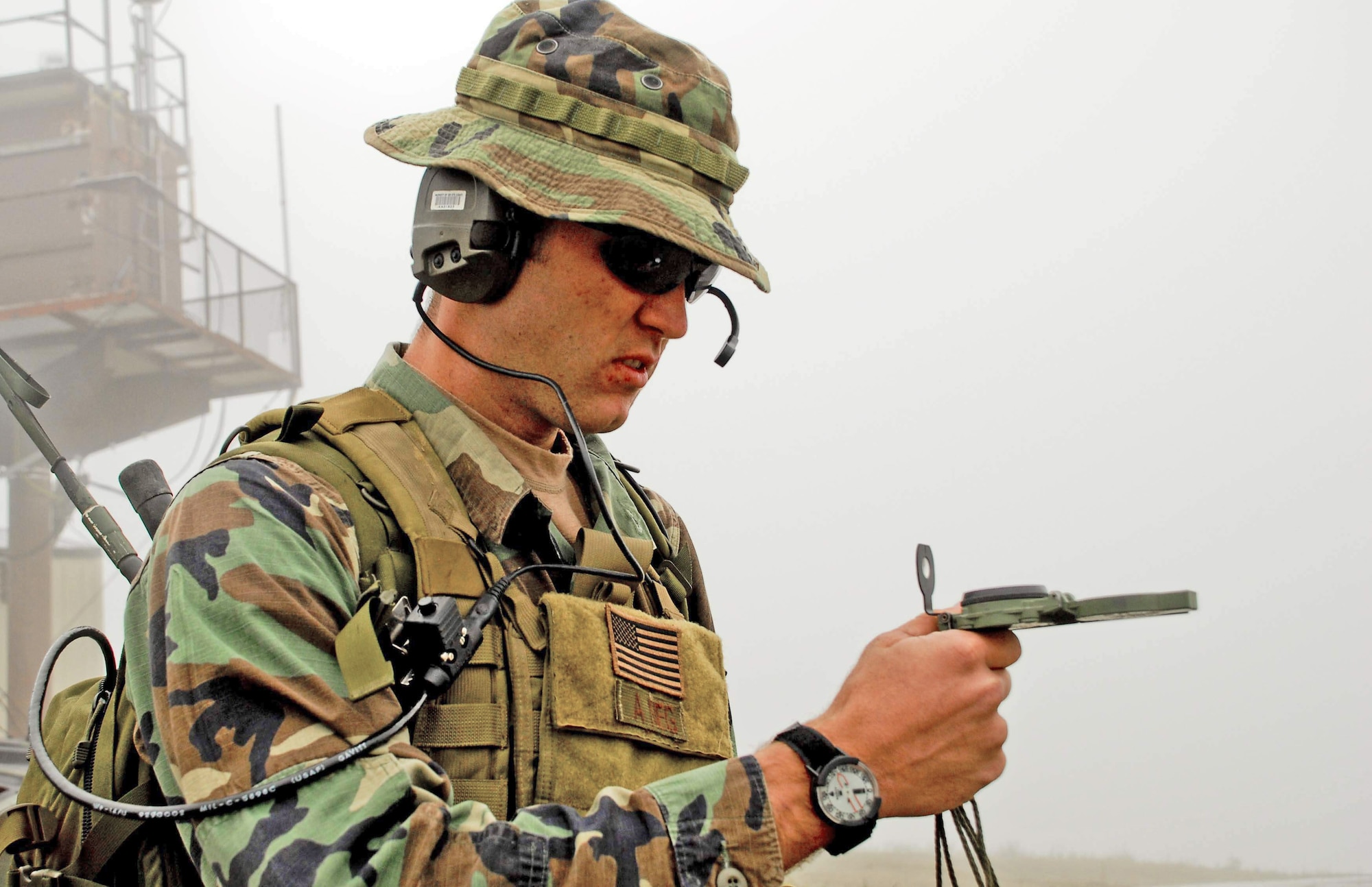 An Air Force combat controller from the 320th Special Tactics Squadron based at Kadena Air Base, Japan, uses a compass to help direct pilots to their correct targets. During this mission June 23, several combat controllers called in airstrikes on Fort Wainwright's Range 2205 in Alaska. The training mission was part of Northern Edge 2009, an exercise designed to prepare joint forces to respond to crises in the Asian Pacific region. (U.S. Air Force photo/1st. Lt. John Callahan) 
