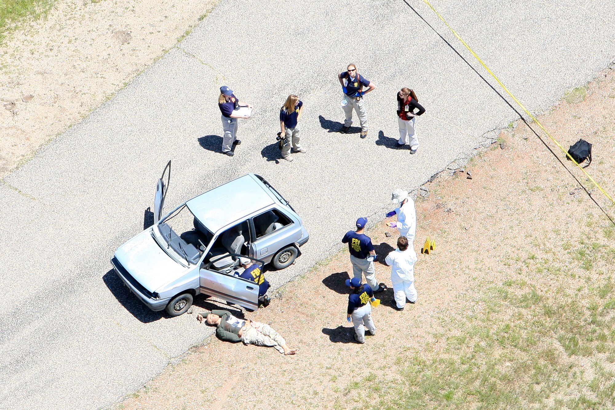 The FBI evidence response team investigates the mock aggressor vehicle during the Nuclear Weapon Accident/Incident Exercise 09 Monday. The continuous 72-hour NUWAIX tested the military's ability to coordinate, cooperate and communicate with other interagency departments and federal, state and local emergency services.