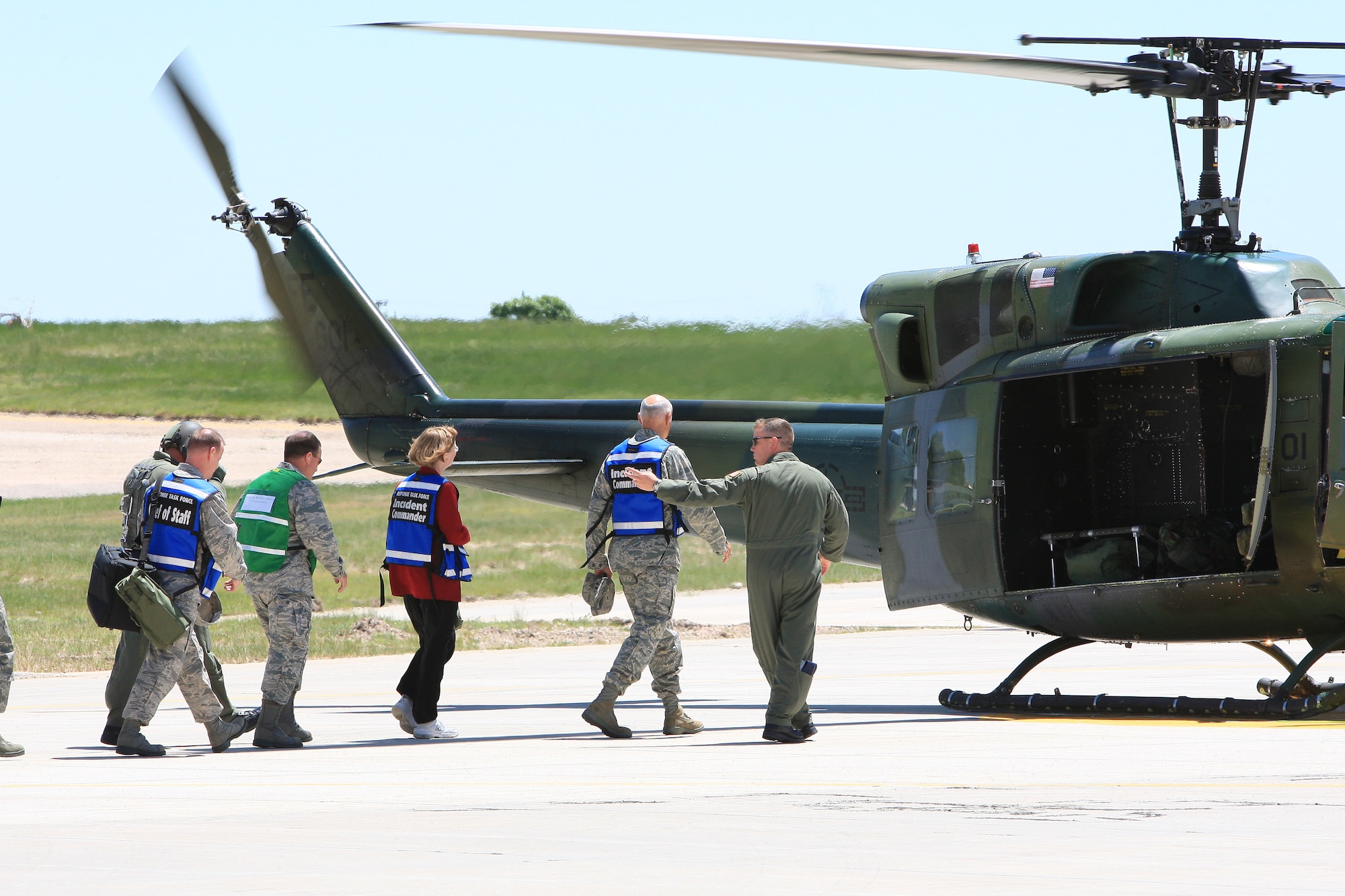Members of the response task force (a DoD response force appropriately staffed, trained and equipped to coordinate all actions necessary to control and recover following a nuclear weapon accident) prepare to board a helicopter to take them to the scene of the incident. Those present are Col. Arthur Beisner, a chief of staff for the RTF; Brig. Gen. Donald Haught, joint task force commander of Wyoming; Chris Puckett, deputy RTF commander; and Maj. Gen. Roger W. Burg, RTF commander.