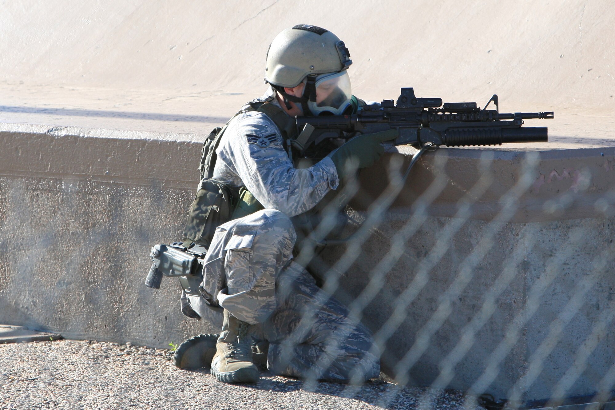Senior Airman Jarod Young, 90th Security Forces Group's tactical response force, provides support to other TRF members as they return the launch facility to positive control during the NUWAIX 09.