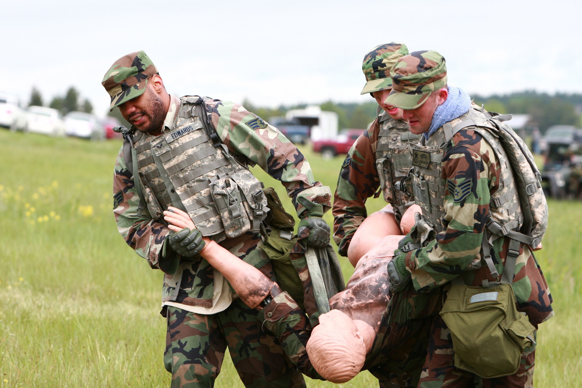 Senior Airman Stefan Edwards, Airman 1st Class Robert McNabb and Staff Sgt. Jason Belcher, all from the 90th Missile Security Forces Squadron, transport a 185 pound dummy to the finish line of the timed Ruck-N-Pack event. The teams had to move three ruck sacks, assorted equipment and the dummy to the designated area to complete the test.