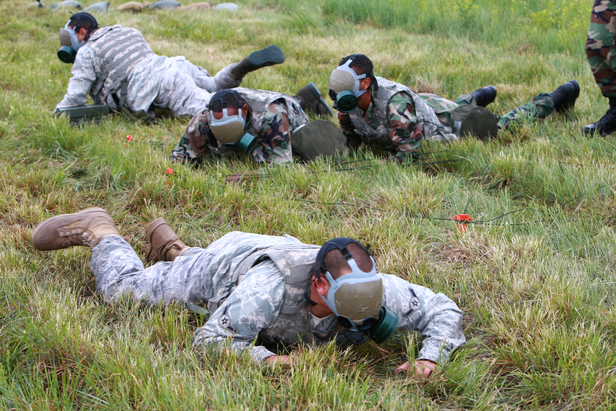 This challenge tested a team's ability to search for an ammunition box while blinded by an obscured gas mask. Once one team member found the box, all other members had to crawl toward and touch the box as well.