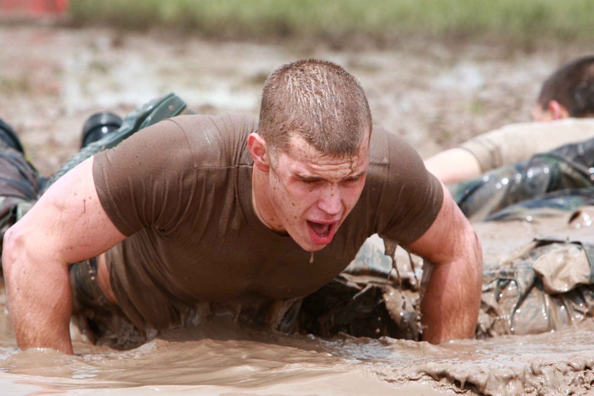 Airman 1st Class Matthew Rowe, 90th Missile Security Forces Squadron, struggles to do one more repetition of the four-man push up part of the Team Pain event of the Crow Creek Challenge. The challenge tests security forces' combat skills and physical and mental ability. Warren is the only Air Force base that has this specific challenge, and only Airmen with ranks of airman basic through staff sergeant can compete.

This event requires the Airmen to do four-man push ups, carry a log a certain distance and then fireman carry each other back to the pit. Teams earn points for doing as many cycles as they can in the allotted time.
