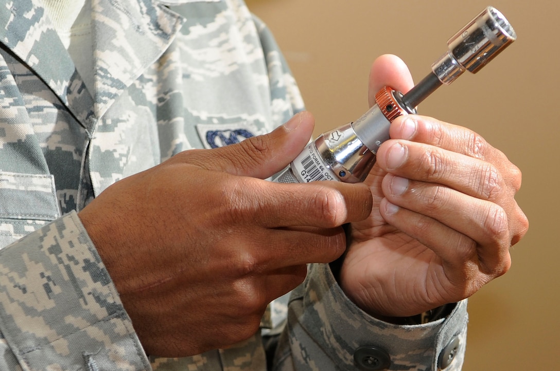 Airman 1st Class Devin Hewitt, 28th Operations Support Squadron aircrew flight equipment apprentice, adjusts a torque wrench to put a hex nut on a life preserver unit here, June 25. Airman Hewitt is responsible for inspecting, maintaining, packing and adjusting aircrew flight equipment. (U.S. Air Force photo by Airman 1st Class Corey Hook)