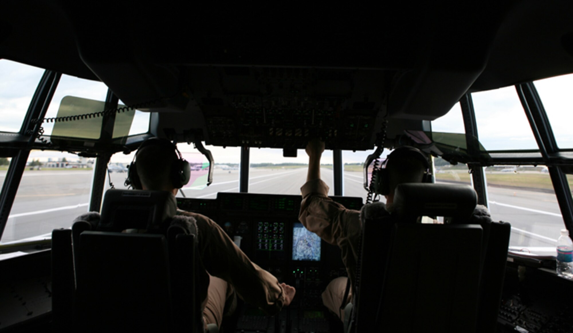 ELMENDORF AIR FORCE BASE, Alaska -- Maj. James Nixon, left, the detachment officer in charge for Marine Aerial Refueler Transport Squadron 152, and Capt. Nathan Shively, a pilot with VMGR-152, skillfully land a KC-130J on the flightline here after an aerial refueling mission June 22. (U.S. Air Force photo/Marine Corps Sgt. Zachary Dyer)