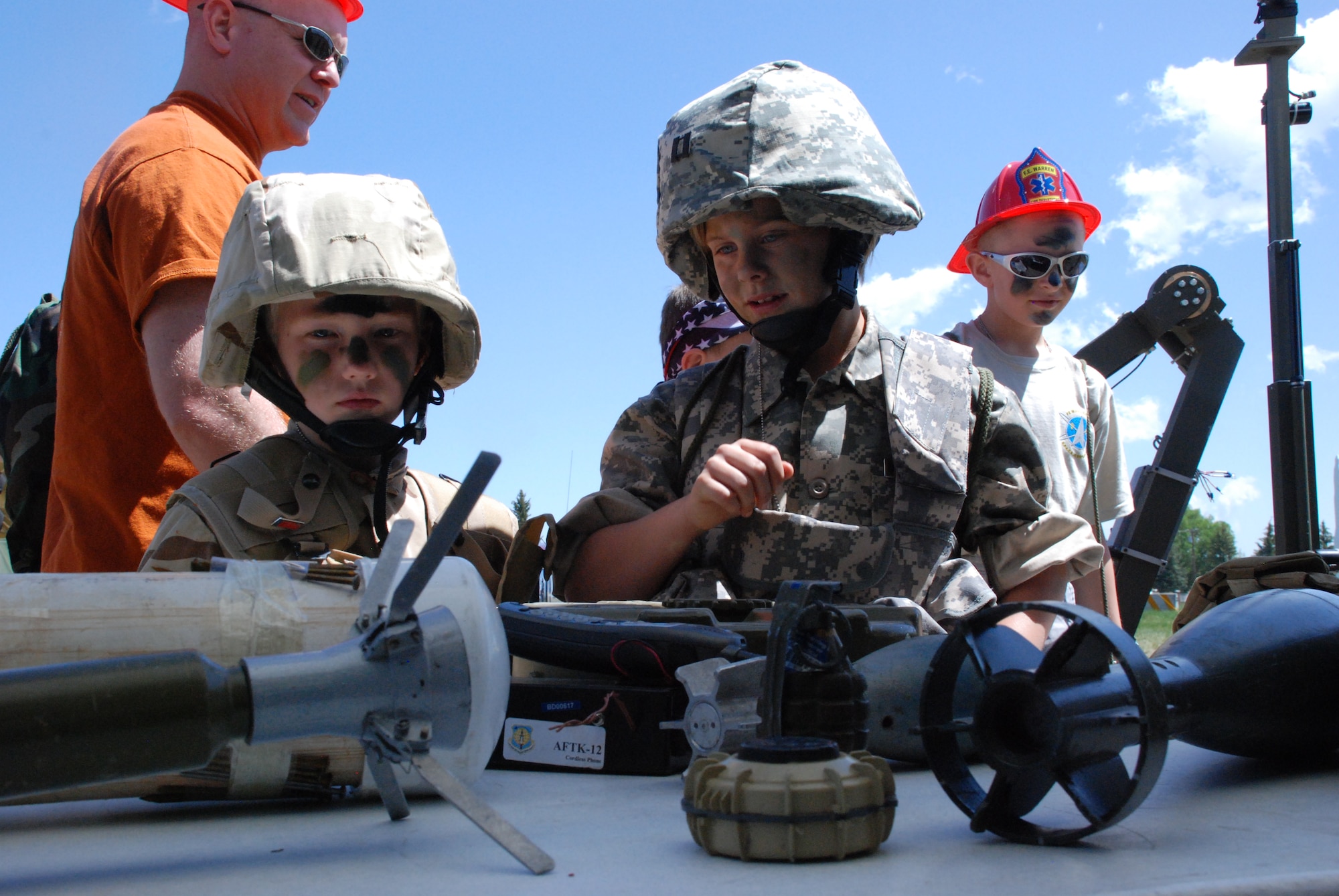 During the Jr. Deployer event June 6, Max Schrader and Sophia Webber examine the different forms of what people use to create improved explosive devices. The mock deployment began with an in-processing line, followed by a tour of the Wyoming Air National Guard base and a landing in FEWastan, a fictional area where the children deployed. After the children saw and participated in the displays in FEWastan, they returned to the Youth Center staging area for a return-home party. 