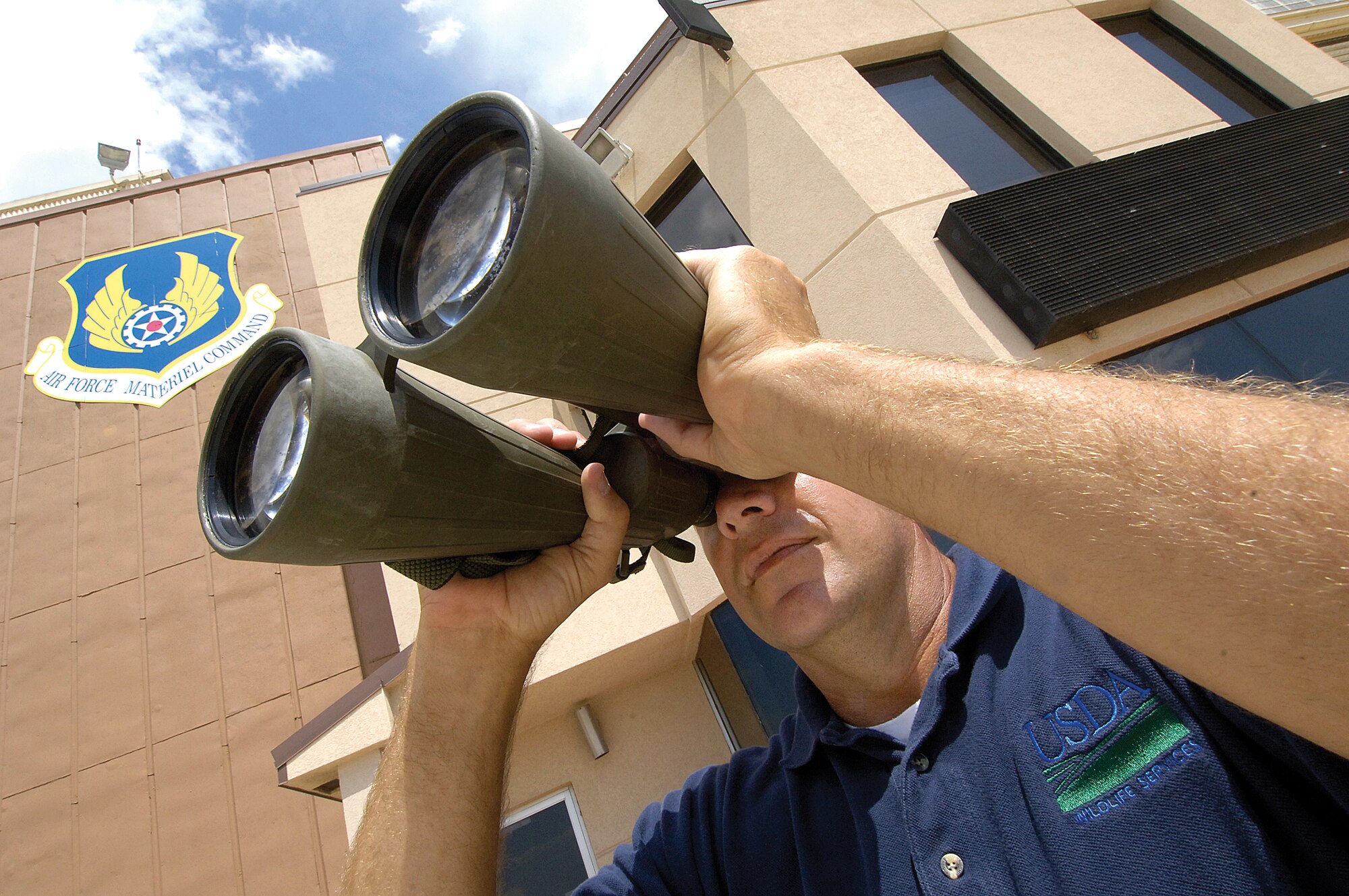 Simple tools such as powerful binoculars help USDA wildlife biologist Clarke Baker scan the Tinker airfield for bird problems.  Birds are a constant problem, but spring, fall and rainy weather keep Mr. Baker and his co-worker the busiest as flocks of migrating birds present the biggest threat to aircraft. While birds are the most common hazard on Tinker’s airfield, coyotes and other mammals can also be a problem and keep the authorized wildlife team busy.