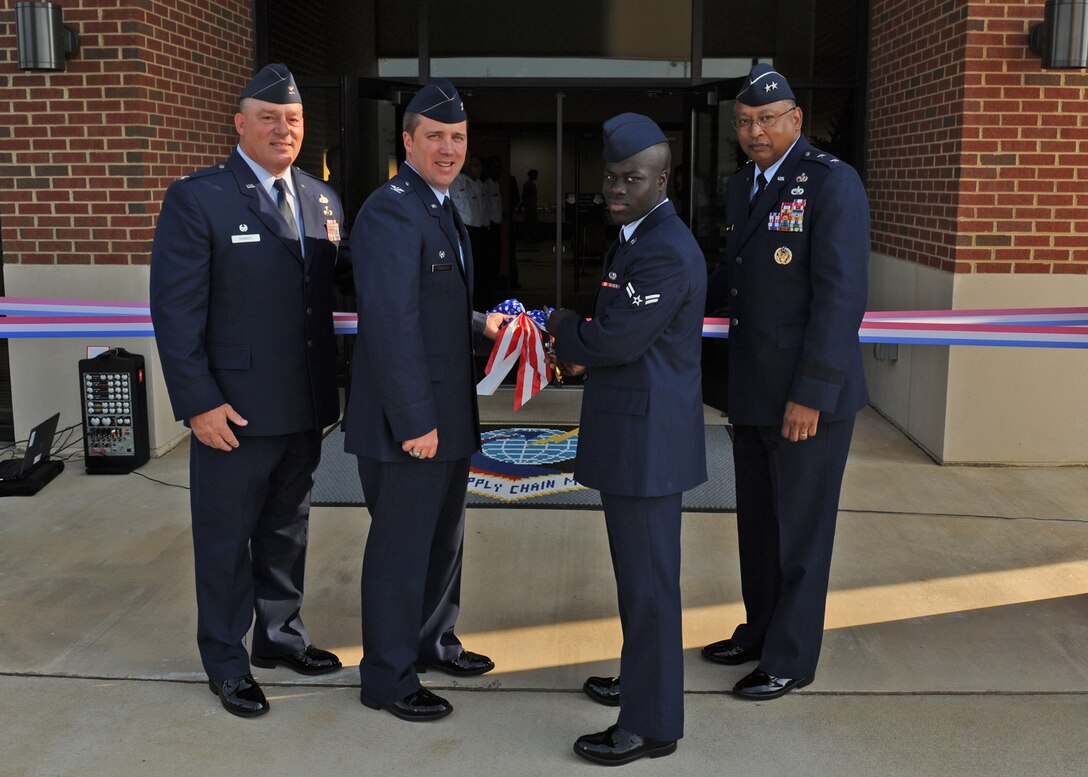 LANGLEY AIR FORCE BASE, Va. -- Col. Rick Bennett, 635th Supply Chain Management Group commander, Col. Roger Thrasher, 735th SCMG commander,  Airman 1st Class Jerome Gardener, 735th SCMG, and Maj. Gen. Gary T. McCoy Air Force Global Logistics Support Center commander, cut the ribbon for the new 735th Supply Chain Management Group building here June 26. The new building was built to accommodate more employees and improve working conditions for 735th SCMG personnel.  (U.S. Air Force photo/Airman 1st Class Jonathan Koob)