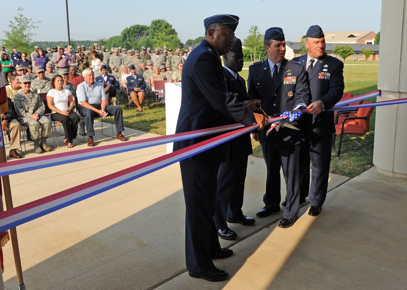 LANGLEY AIR FORCE BASE, Va. -- Maj. Gen. Gary T. McCoy Air Force Global Logistics Support Center commander, Airman 1st Class Jerome Gardener, 735th Supply Chain Management Group, Col. Roger Thrasher, 735th SCMG commander,  and Col. Rick Bennett, 635th SCMG commander, cut the ribbon for the new 735th Supply Chain Management Group building here June 26. The new building was built to accommodate more employees and improve working conditions for 735th SCMG personnel.  (U.S. Air Force photo/Airman 1st Class Jonathan Koob)